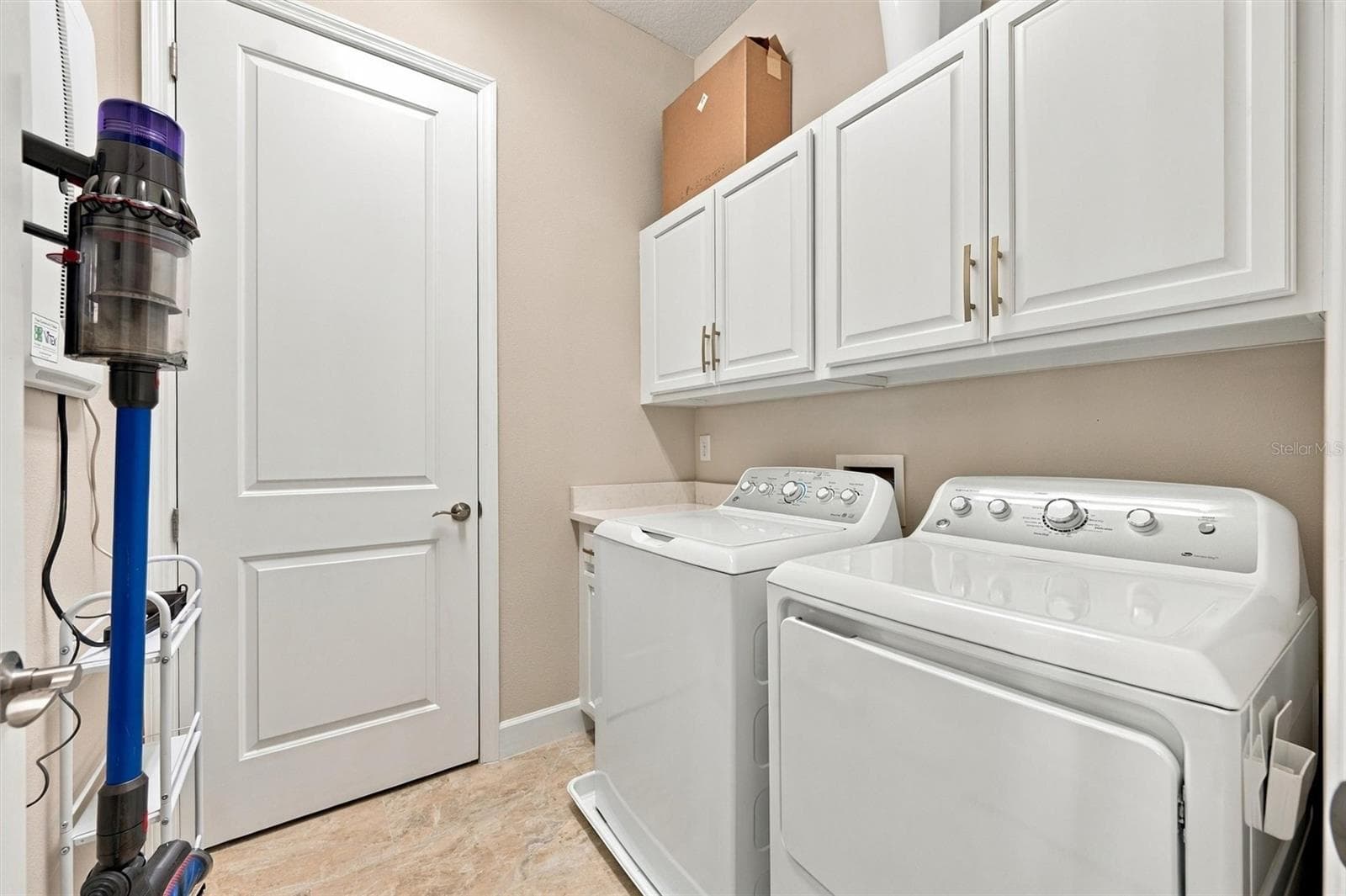 Laundry room with extra storage - 291 COMPASS POINT DR #201, BRADENTON