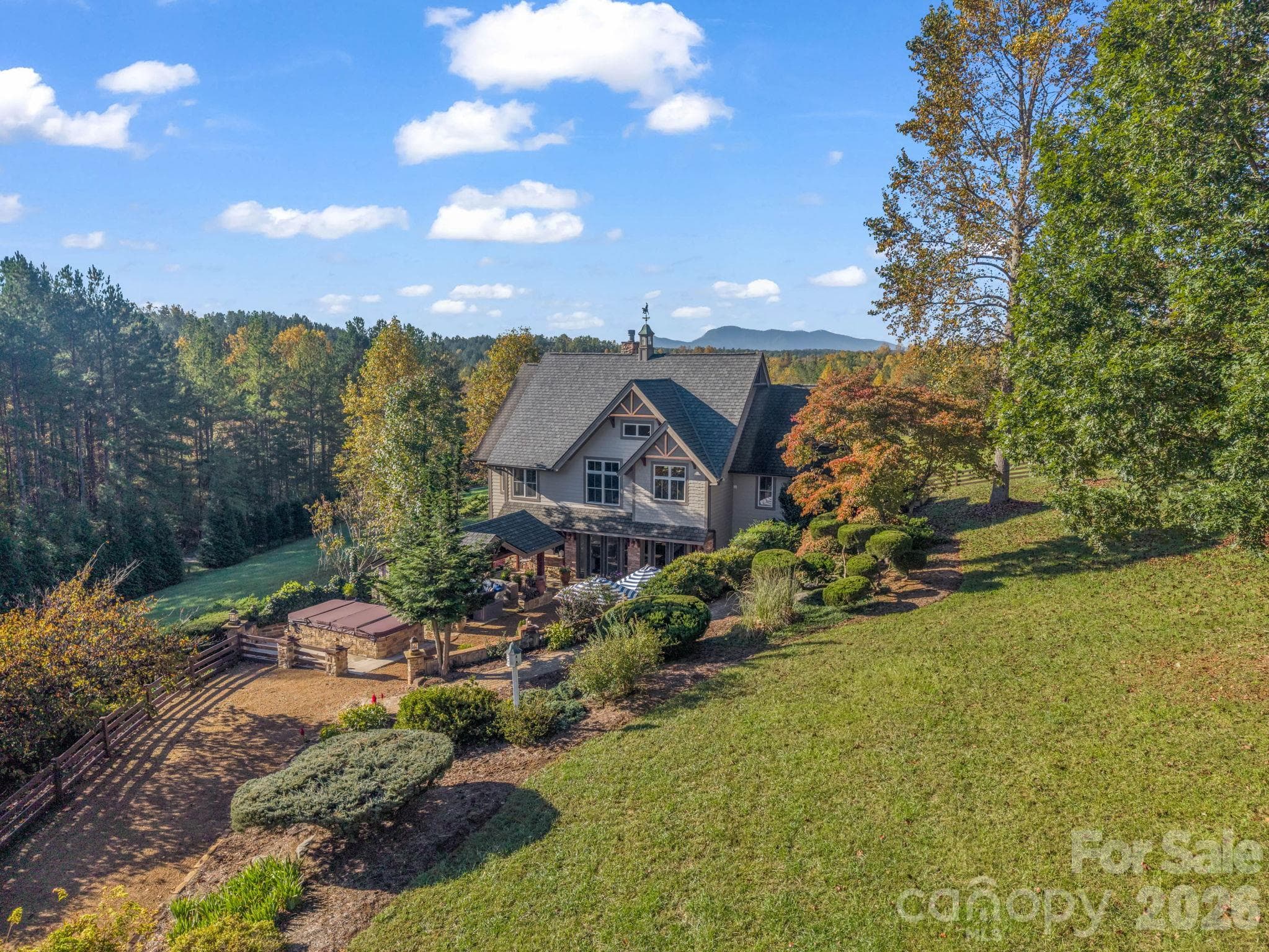 Aerial showcasing the mountain views, privacy and landscaping, notice swim spa and covered pavilion with Italian inspired ambiance - 140 Blazing Star Lane, Mill Spring