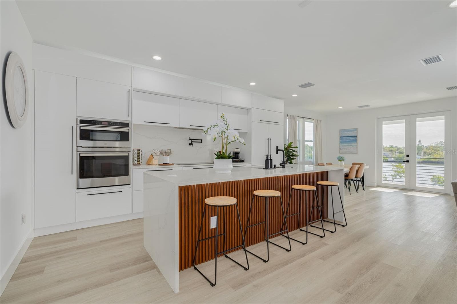Kitchen, dining and living area on main level with beautiful water views. - 7609 DEEDRA CIR, PORT RICHEY