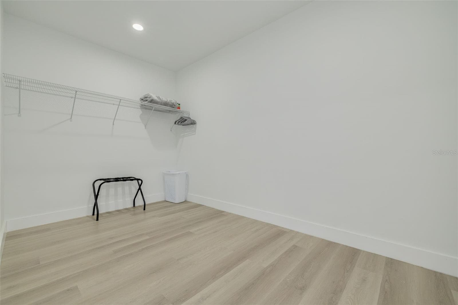 Large walk in closet with a section for a large built-in safe on the right side. - 7609 DEEDRA CIR, PORT RICHEY