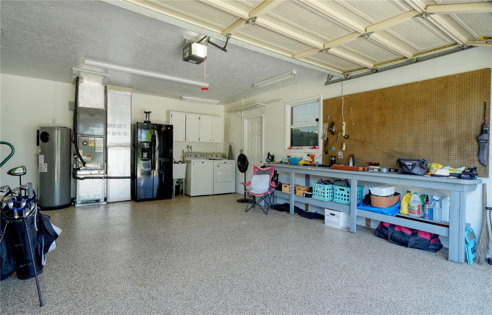 Epoxy coated floor in 2 car garage, with laundry and second refrigerator and workbench - side door leads to RV/Boat trailer parking pad behind double door Vinyl fence - 2304 50TH ST W, BRADENTON