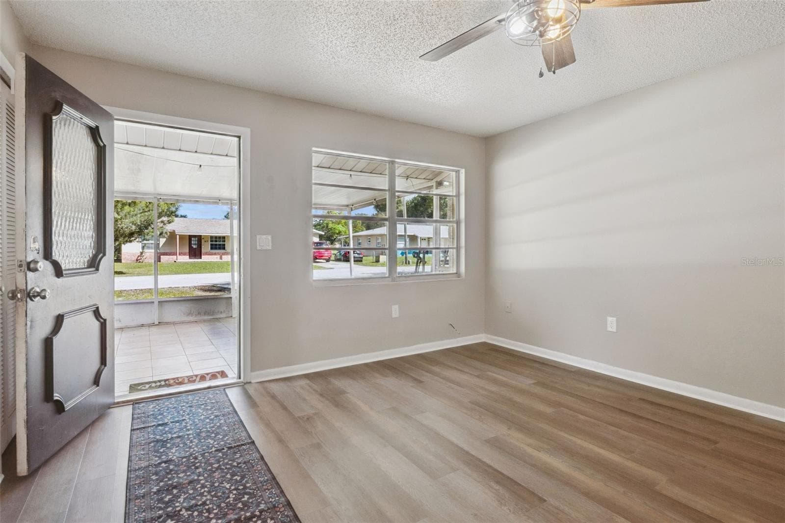 Living Room with ceiling fan and vinyl flooring. - 416 WINNERS CIR, LADY LAKE