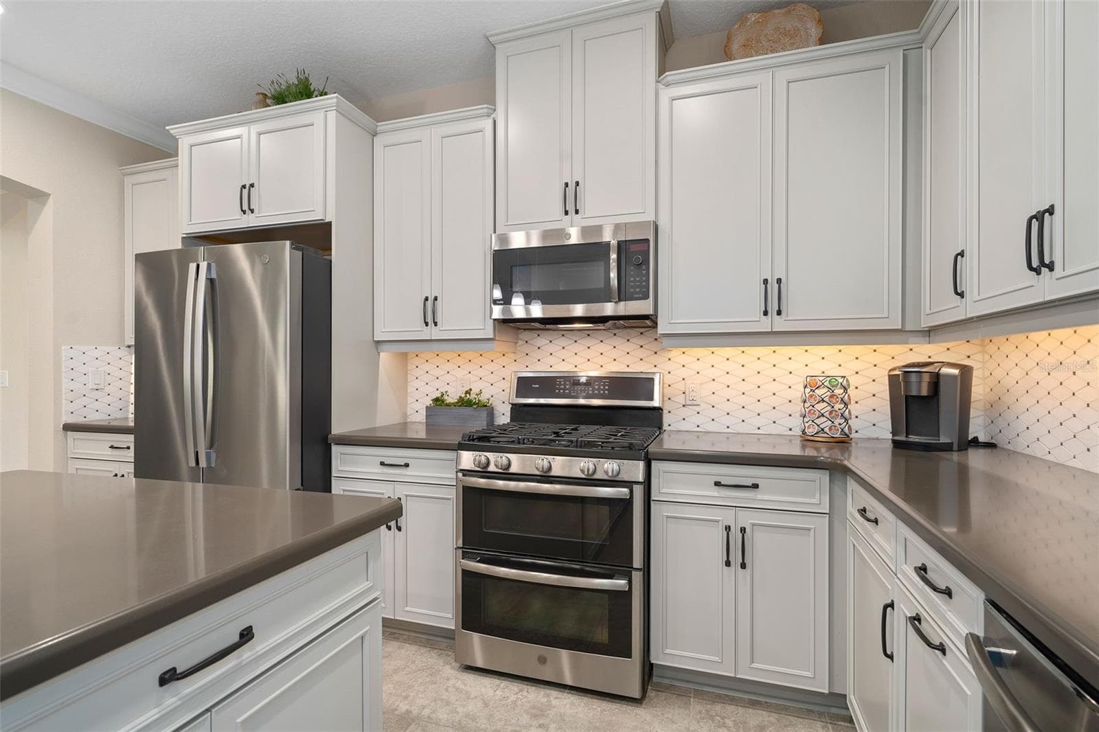 The Kitchen offers great counter / prep space and the Microwave is vented to the outside. - 2607 CLEMSON RIDGE CT, CLERMONT