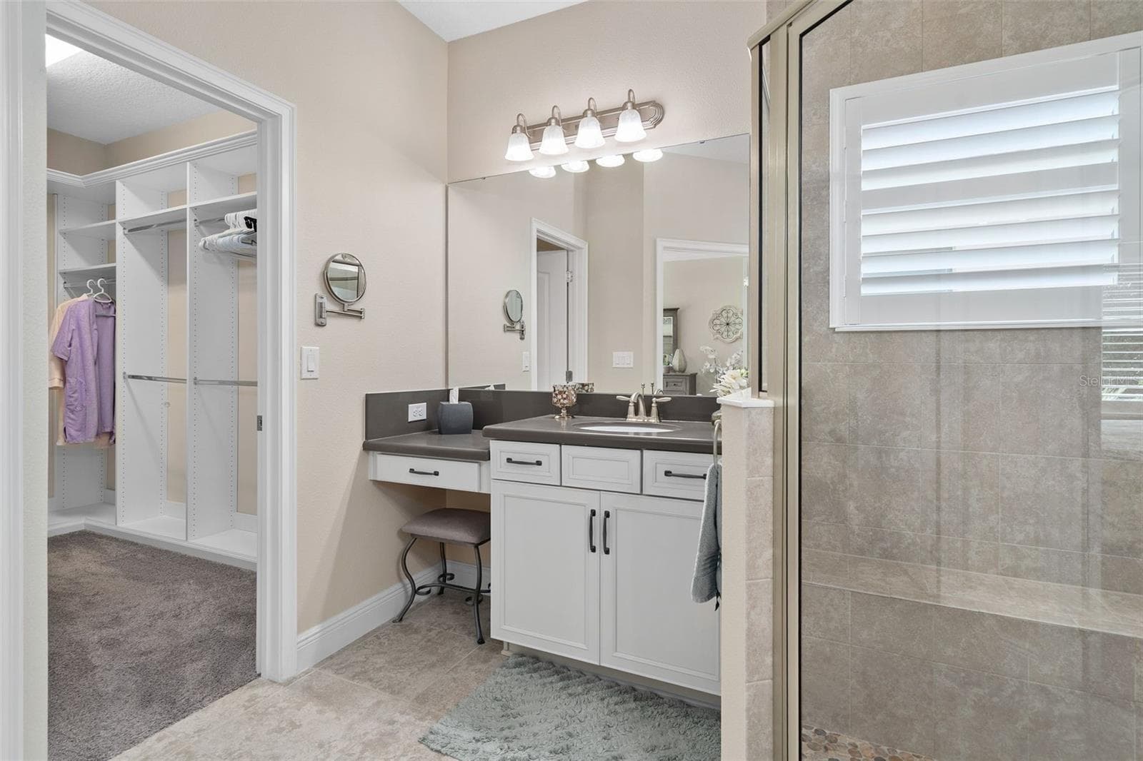 Primary En-Suite offering Comfort Height split vanities, Quartz Counters and a custom Organized Walk-in closet. - 2607 CLEMSON RIDGE CT, CLERMONT