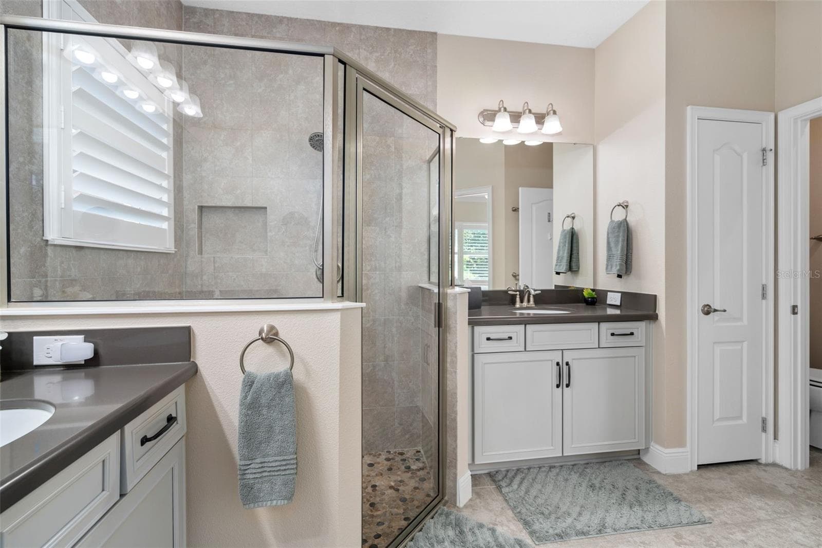 The Primary En-Suite Shower offers Upgraded Wall and Floor Tile. There is also a Linen closet and Water Closet. - 2607 CLEMSON RIDGE CT, CLERMONT