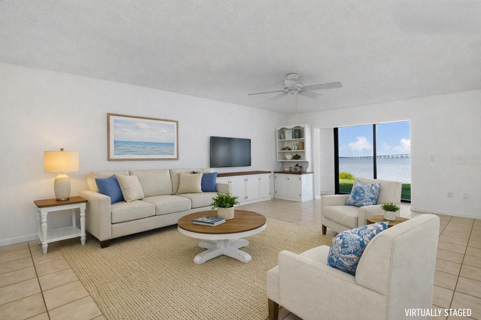 Virtually staged living area with different wall finish - overlooking water view. - 2980 HAINES BAYSHORE RD #105, CLEARWATER