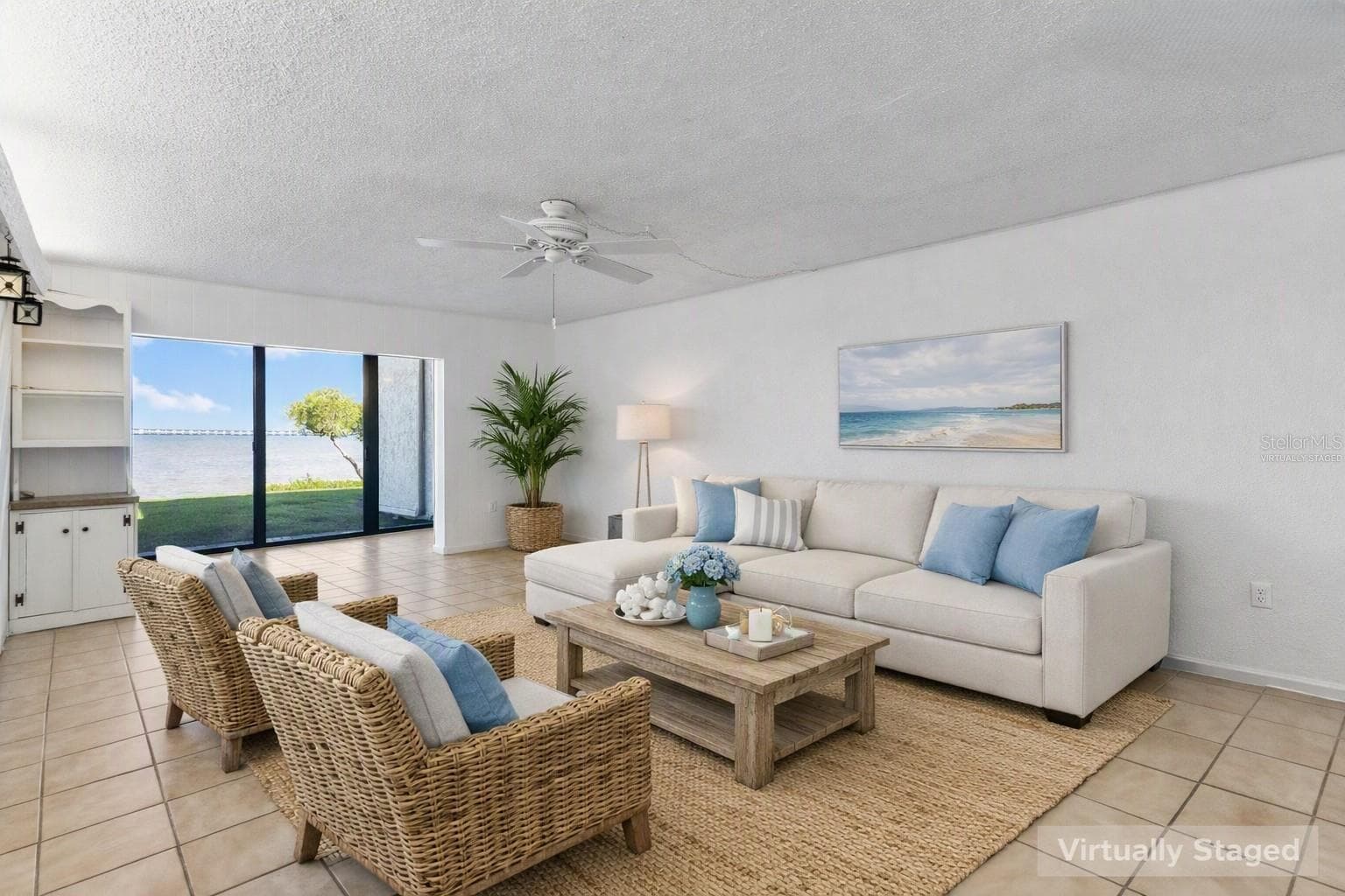 Virtually staged living area looking toward water view. - 2980 HAINES BAYSHORE RD #105, CLEARWATER