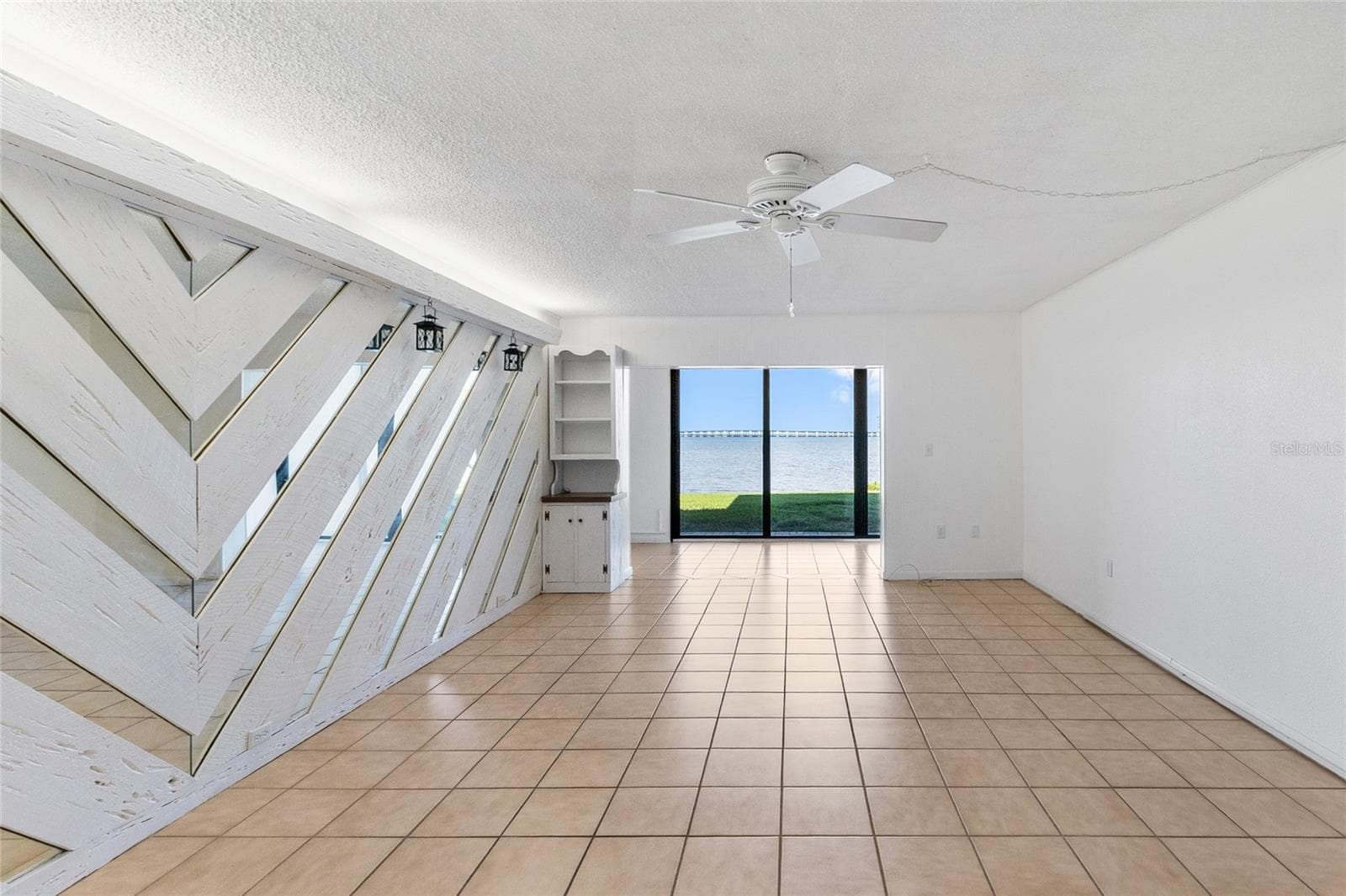 Living room looking directly towards sunroom and water view. - 2980 HAINES BAYSHORE RD #105, CLEARWATER