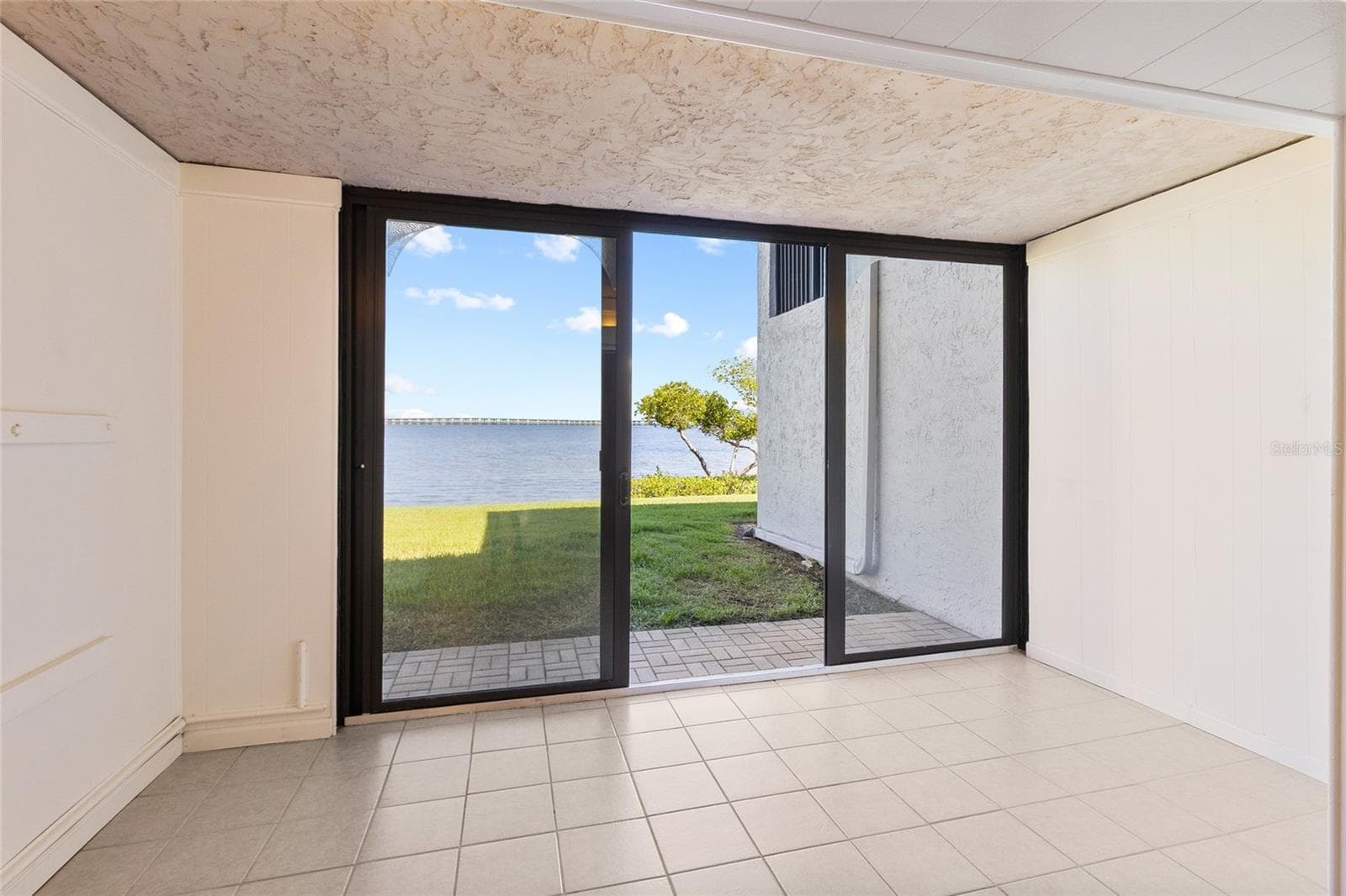 Sunroom directly off Living area - full water view. - 2980 HAINES BAYSHORE RD #105, CLEARWATER