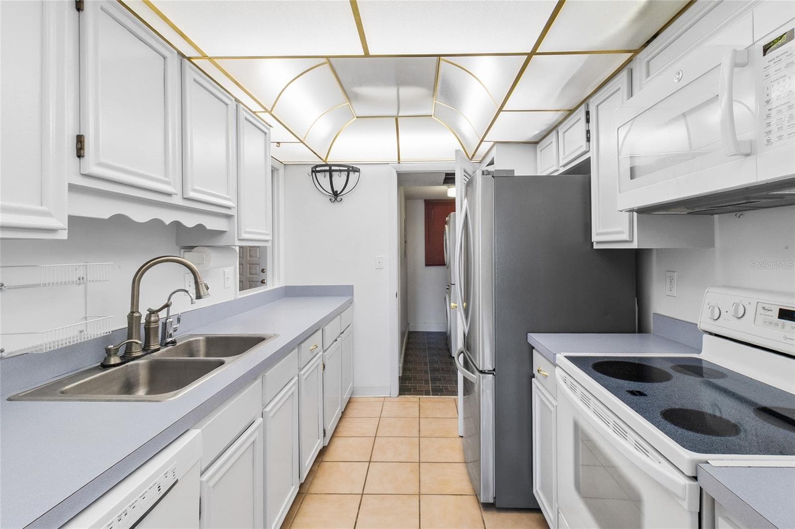 Kitchen looking toward interior laundry room - 2980 HAINES BAYSHORE RD #105, CLEARWATER