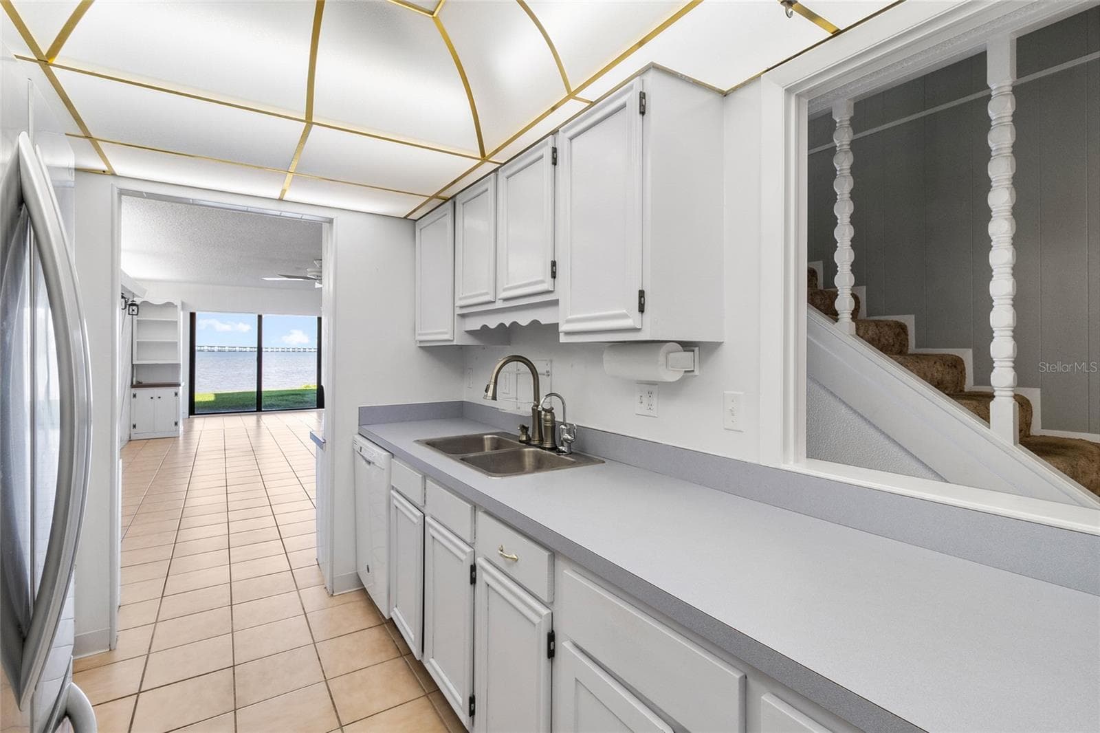 Kitchen other side looking toward living area and water view - 2980 HAINES BAYSHORE RD #105, CLEARWATER