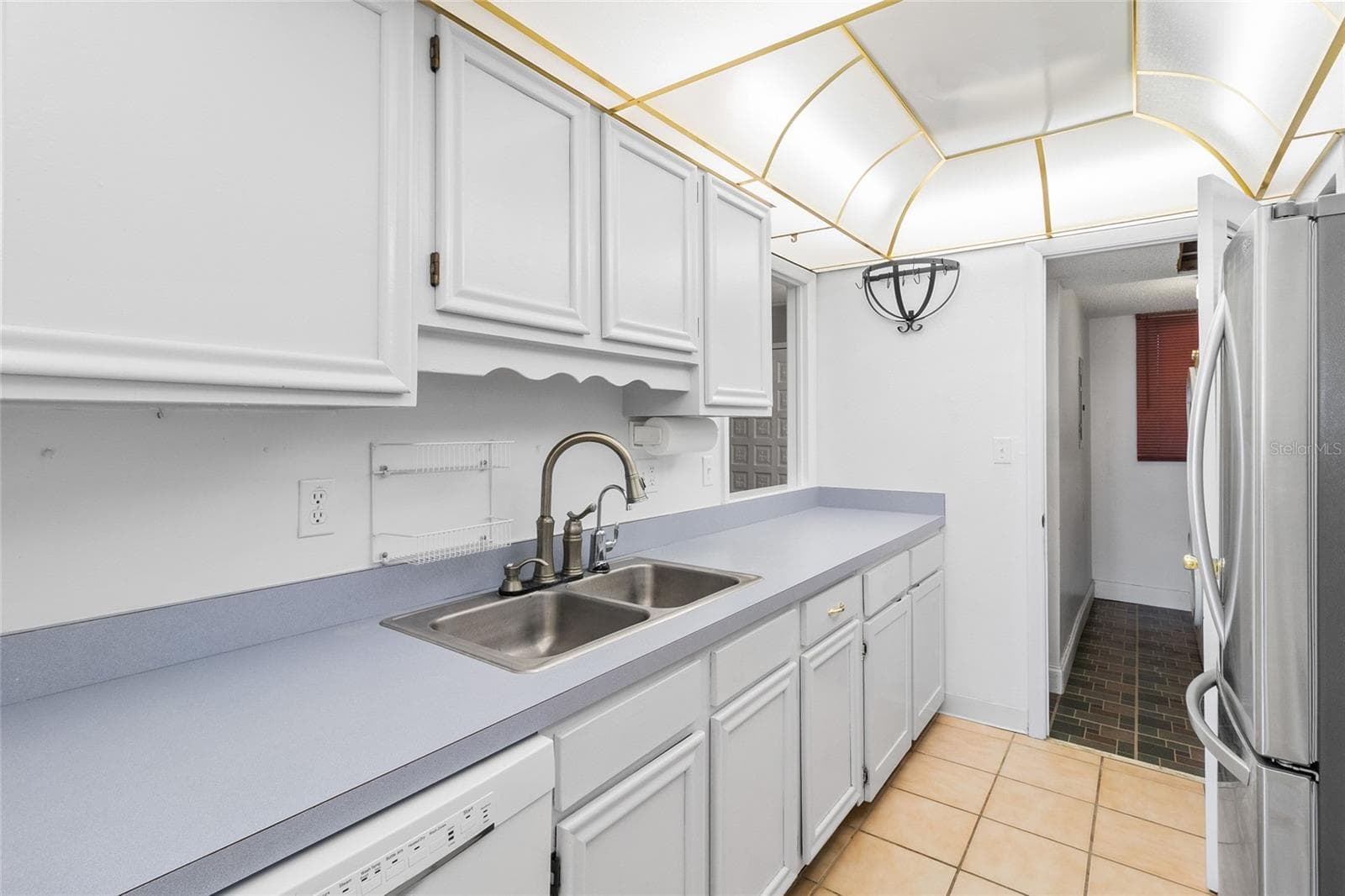 Kitchen looking toward interior laundry room - 2980 HAINES BAYSHORE RD #105, CLEARWATER