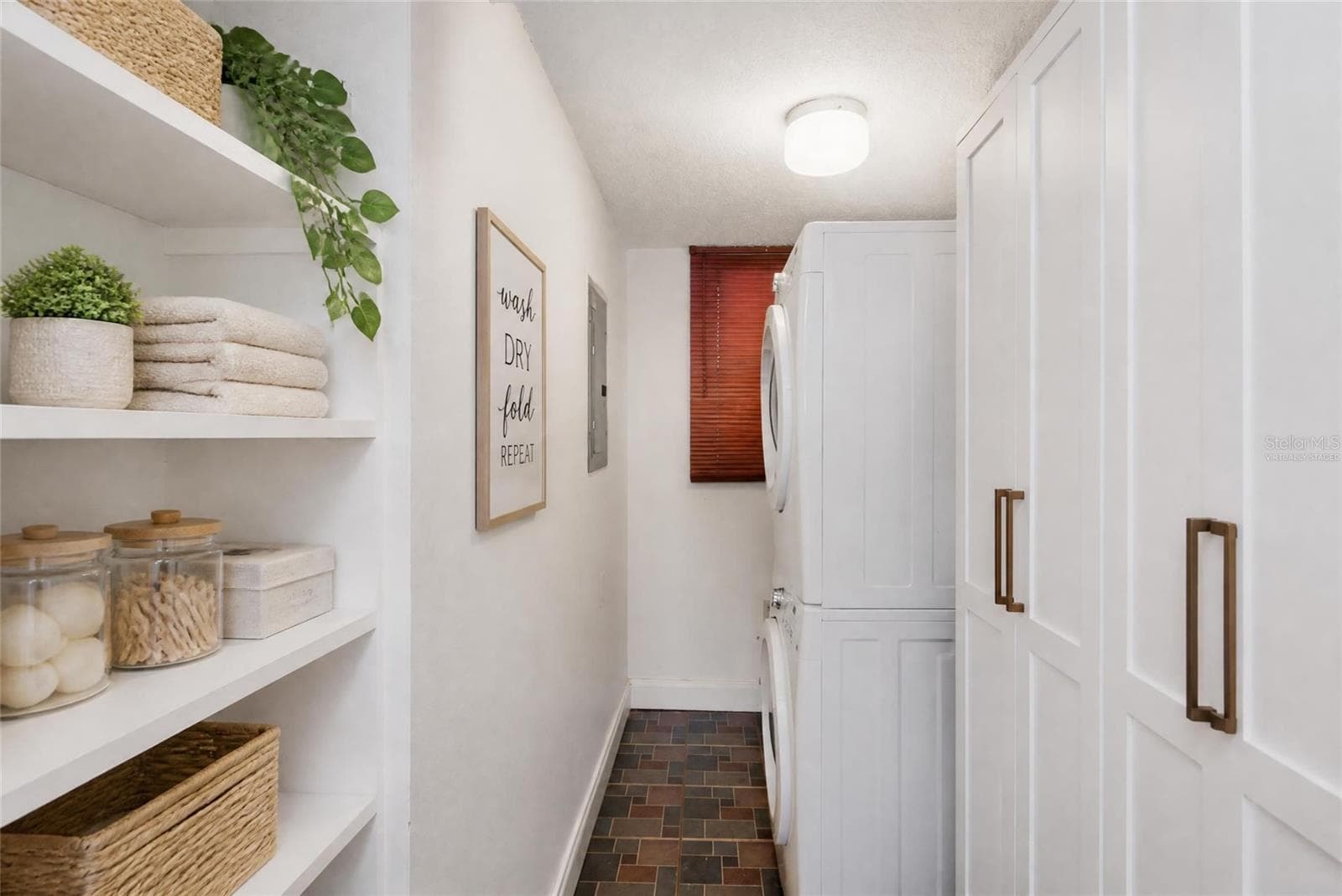 VIRTUALLY STAGED Laundry room - shelved added and HVAC enclosed in cabinets. - 2980 HAINES BAYSHORE RD #105, CLEARWATER
