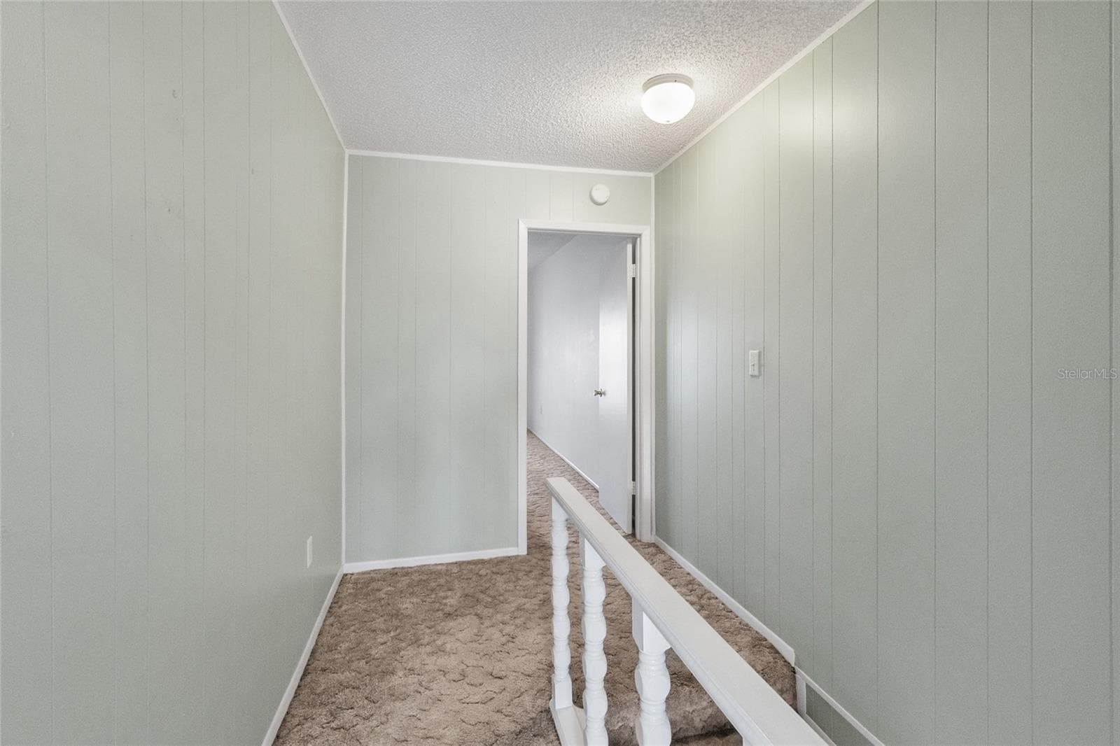 Stairway looking toward primary suite - 2980 HAINES BAYSHORE RD #105, CLEARWATER