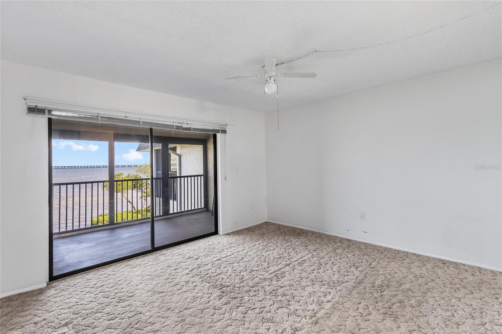 Primary bedroom over looking balcony with full panoramic water views. - 2980 HAINES BAYSHORE RD #105, CLEARWATER