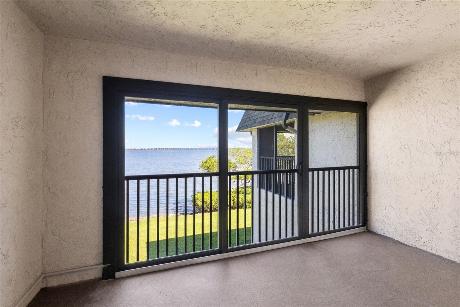 Balcony off primary bedroom - full panoramic water views - 2980 HAINES BAYSHORE RD #105, CLEARWATER