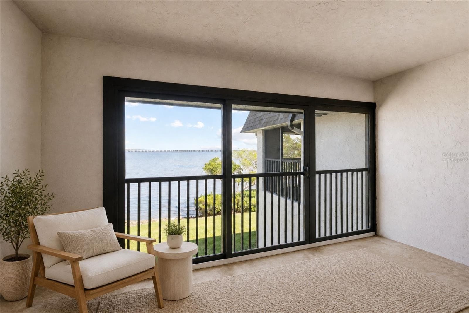 Virtually staged balcony off primary bedroom with panoramic water views - 2980 HAINES BAYSHORE RD #105, CLEARWATER