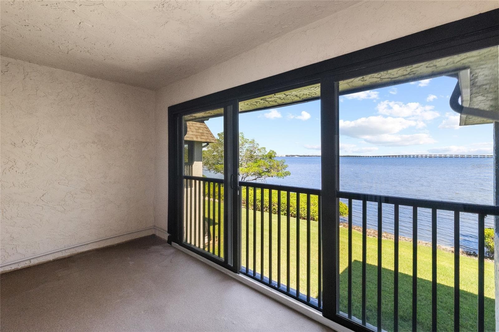 Balcony off primary bedroom - full panoramic water views - 2980 HAINES BAYSHORE RD #105, CLEARWATER