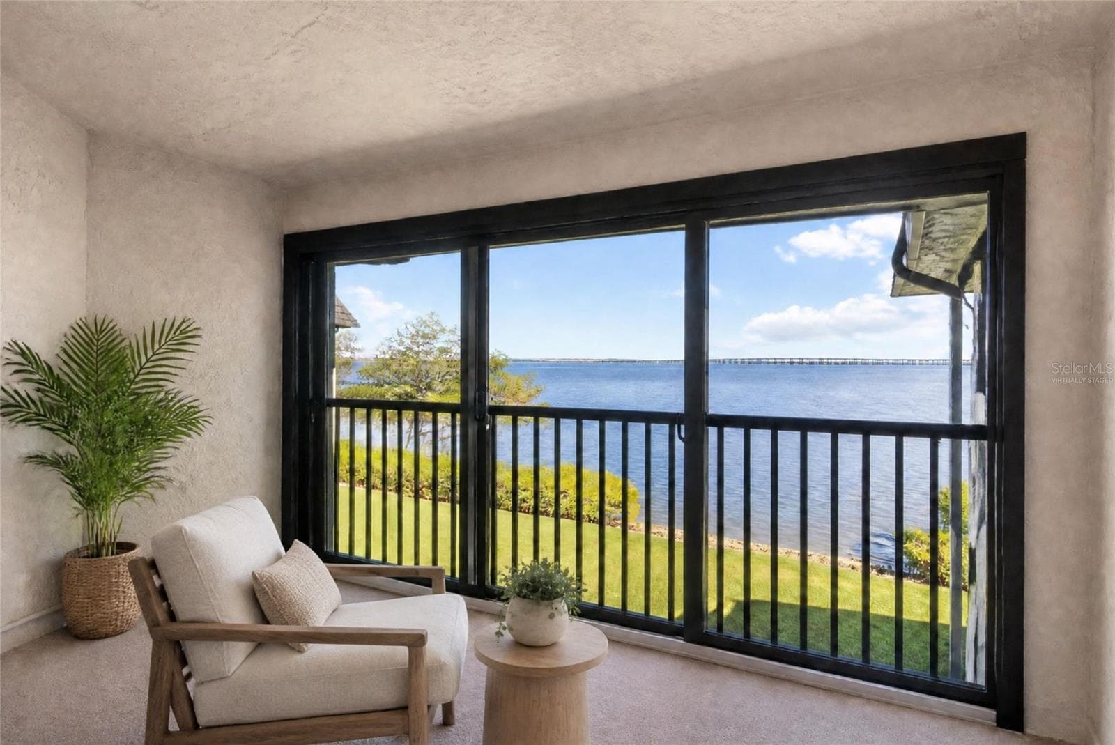 Virtually staged - primary bedroom balcony with water view - 2980 HAINES BAYSHORE RD #105, CLEARWATER