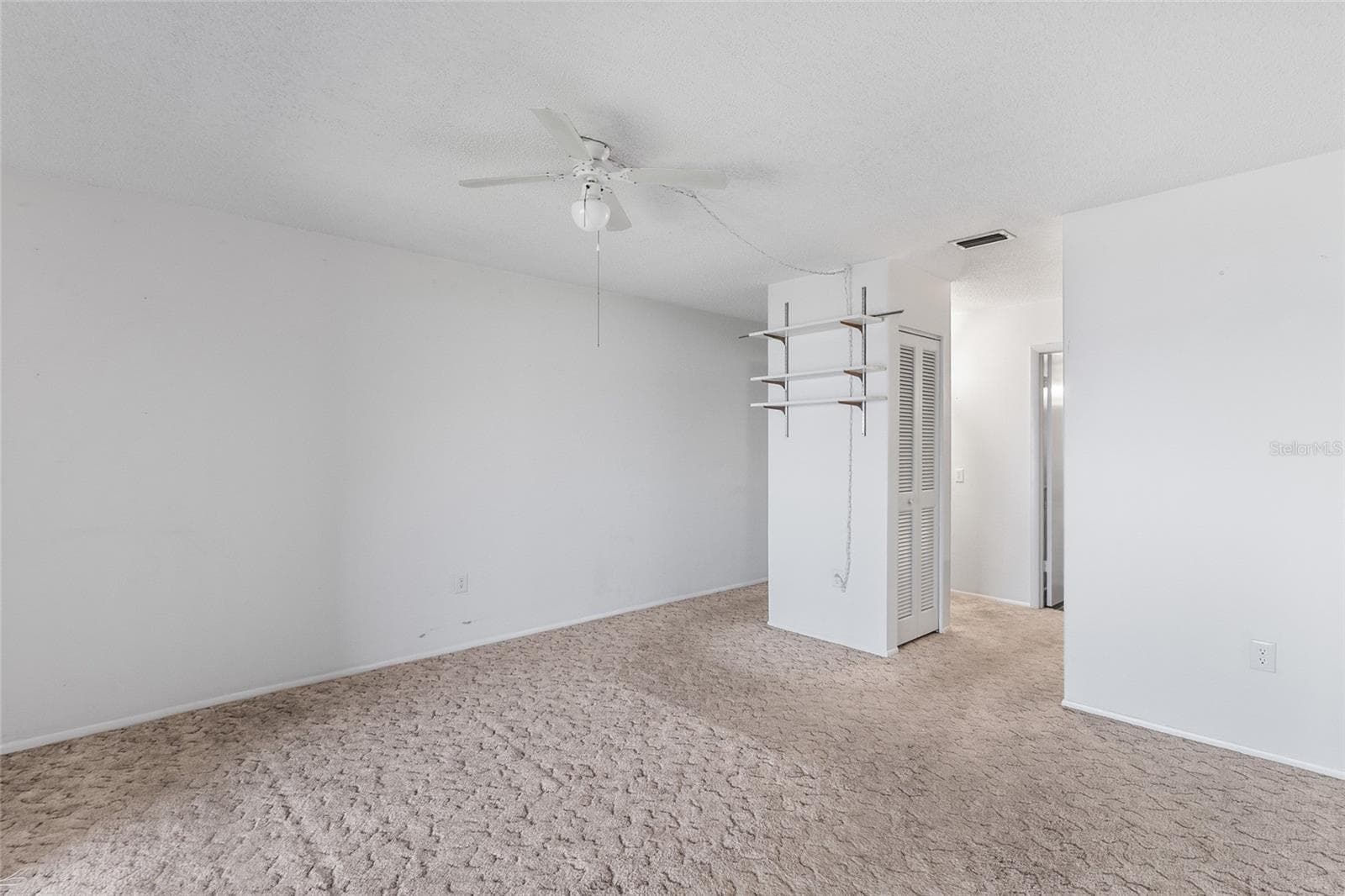 Primary suite looking toward closets and ensuite bath - 2980 HAINES BAYSHORE RD #105, CLEARWATER