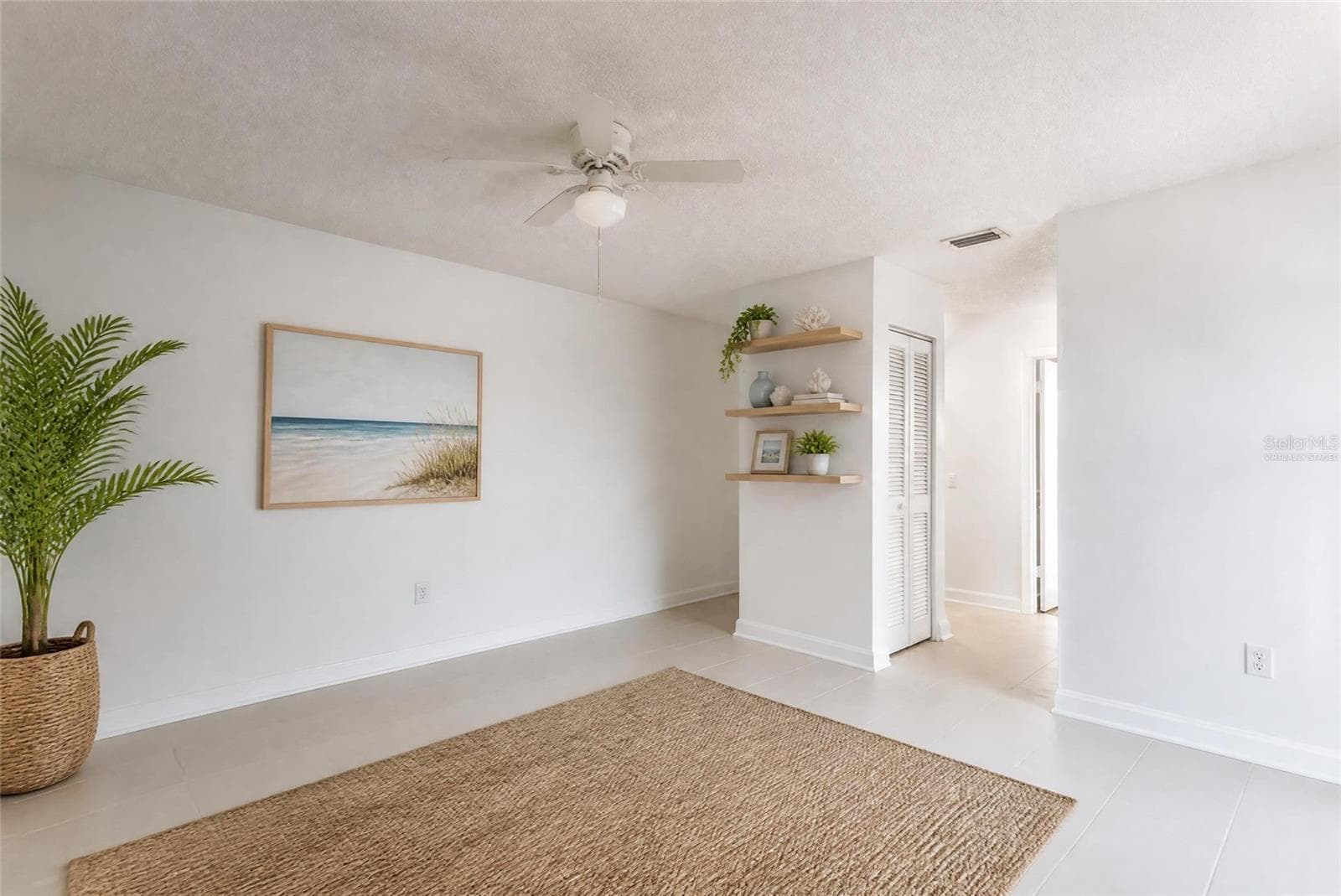 Virtually staged primary suite with tile floors and shelves. Assist in envisioning different flooors - 2980 HAINES BAYSHORE RD #105, CLEARWATER