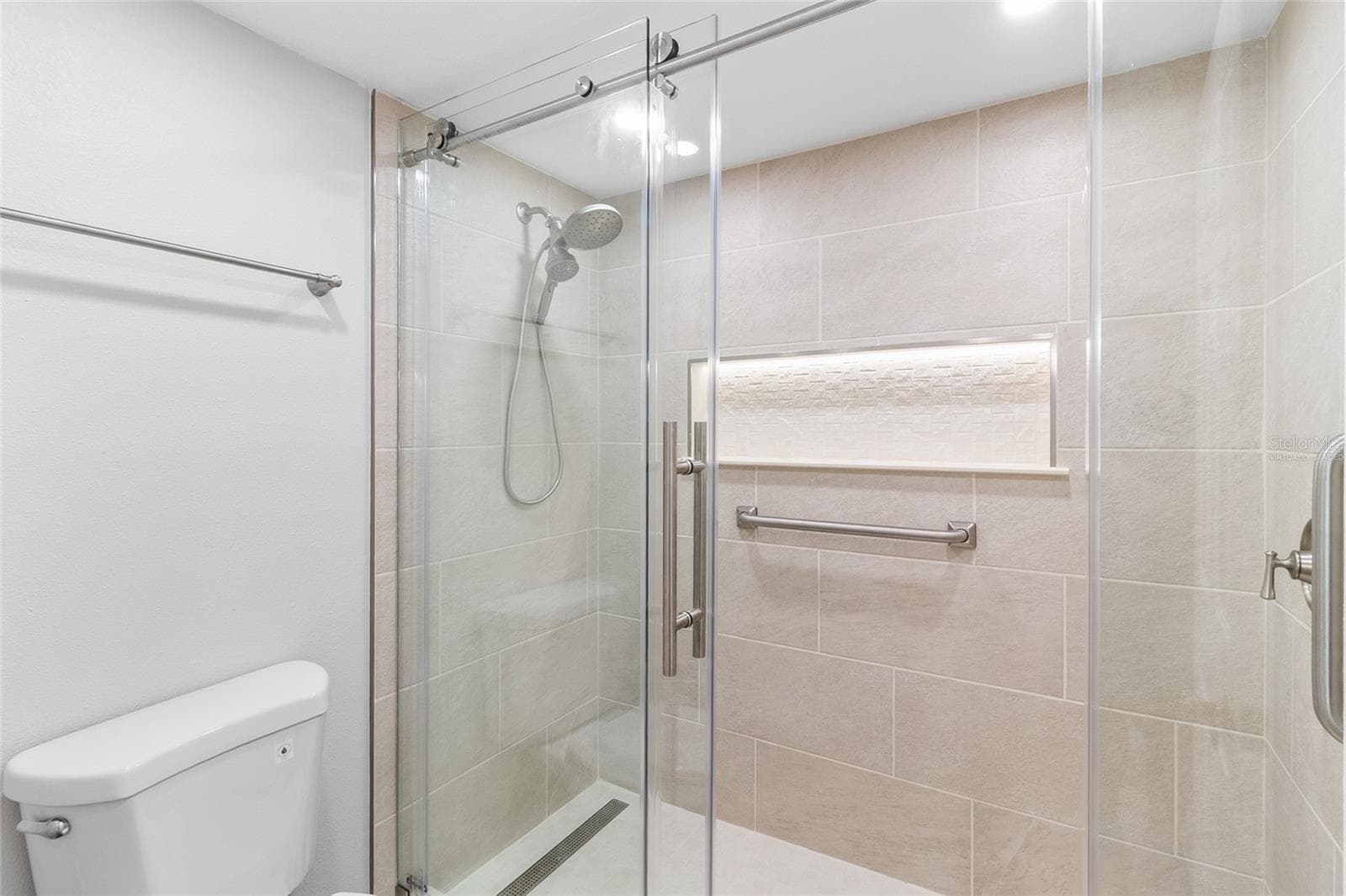 VIRTUALLY STAGED primary bath with updated tile and enclosure - 2980 HAINES BAYSHORE RD #105, CLEARWATER