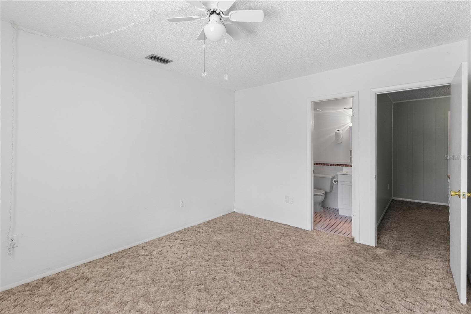 Secondary bedroom looking toward ensuite bath and door - 2980 HAINES BAYSHORE RD #105, CLEARWATER