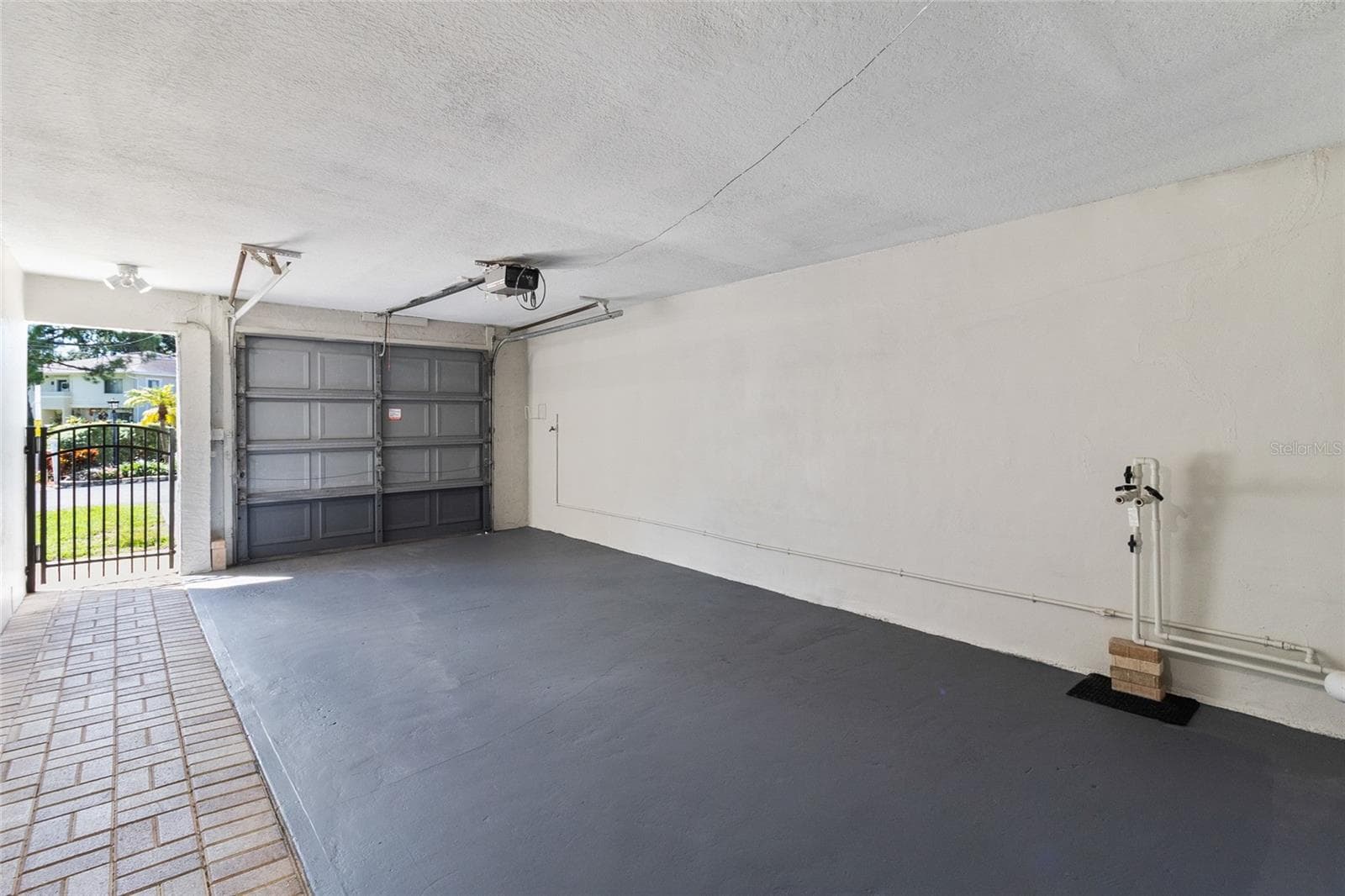 Open concept garage with door, opener and hookup for water softner - 2980 HAINES BAYSHORE RD #105, CLEARWATER