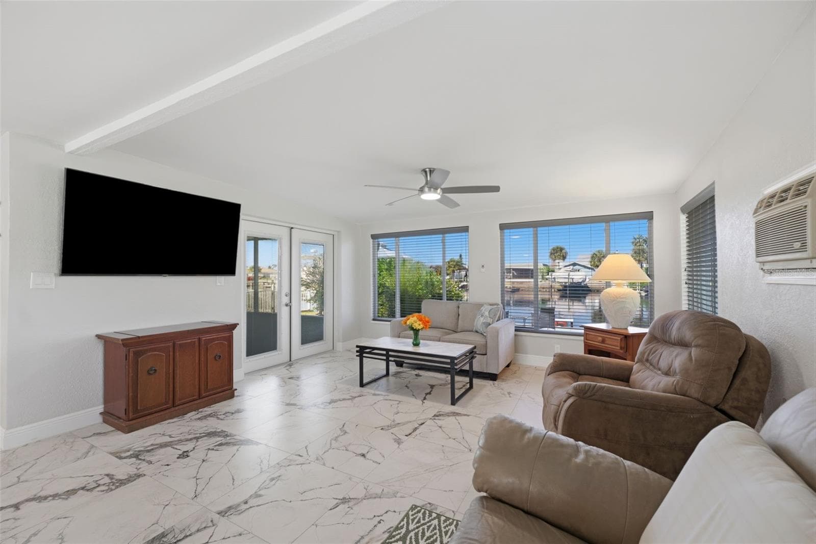 Water view from Family Room - access to the screened FL room with adjustable shades. - 5513 BOWLINE BND, NEW PORT RICHEY