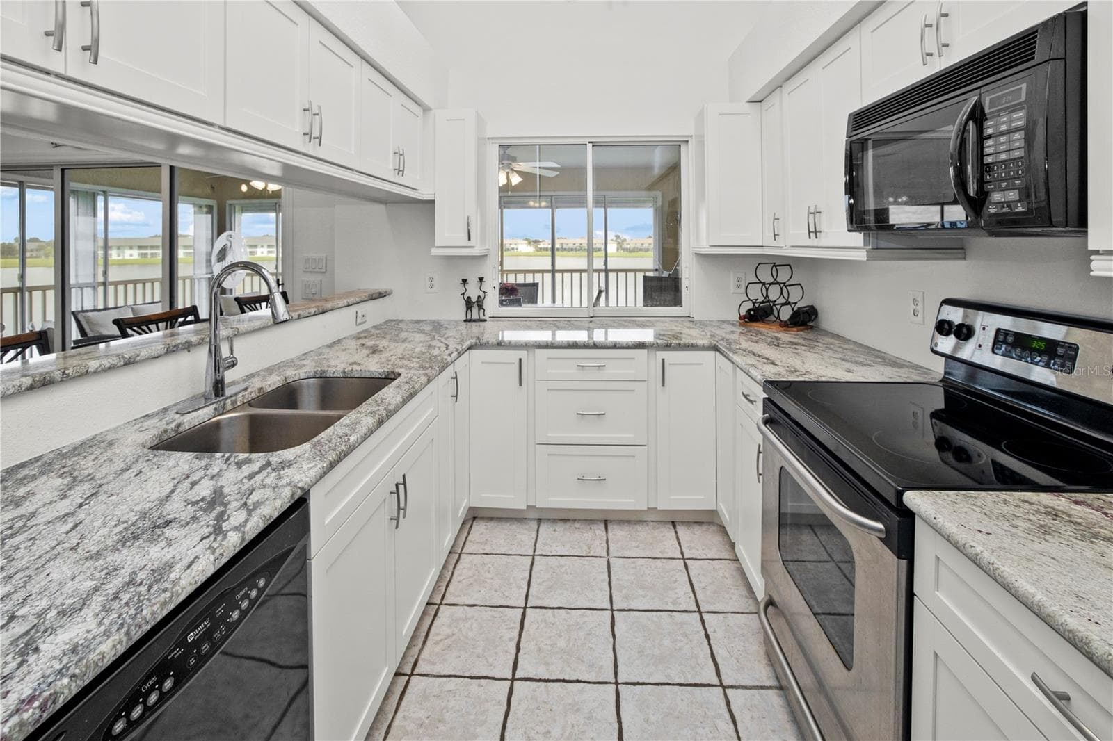 Spacious Kitchen with Gorgeous Granite and a Wonderful View of the Lake - 26283 NADIR RD #201, PUNTA GORDA