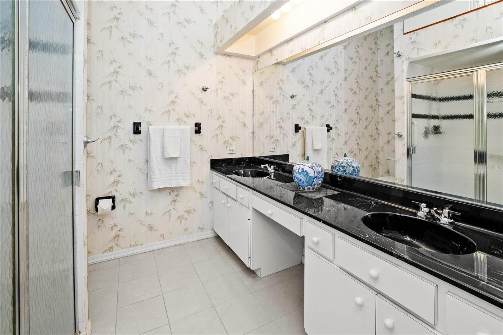 Primary Ensuite Bath Boast Dbl Sinks, Walk In Tiled Shower and lots of storage - 26283 NADIR RD #201, PUNTA GORDA
