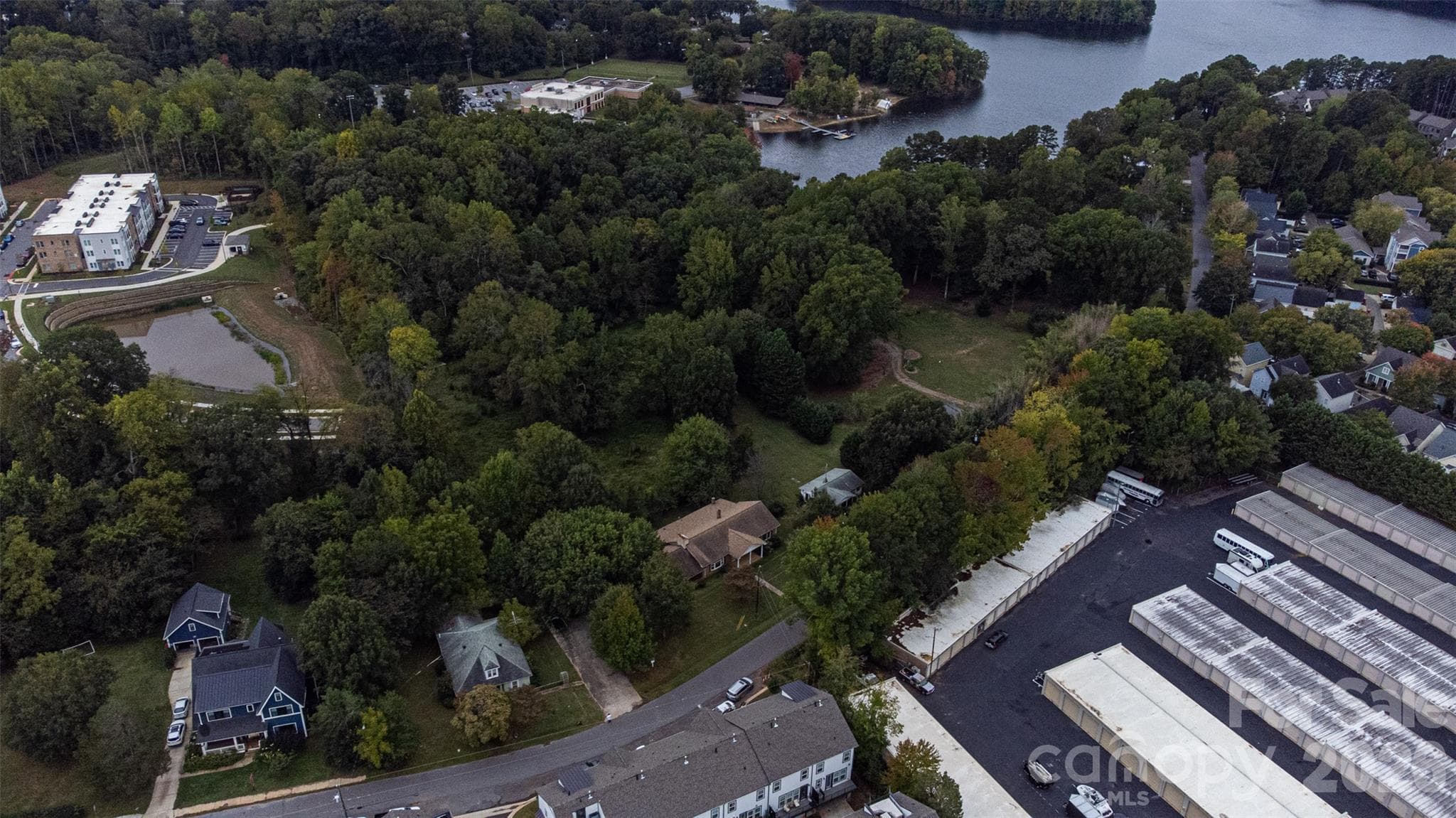 Aerial view of Home and acreage. Across from property are townhomes and a storage facility. - 335 Catawba Avenue, Davidson