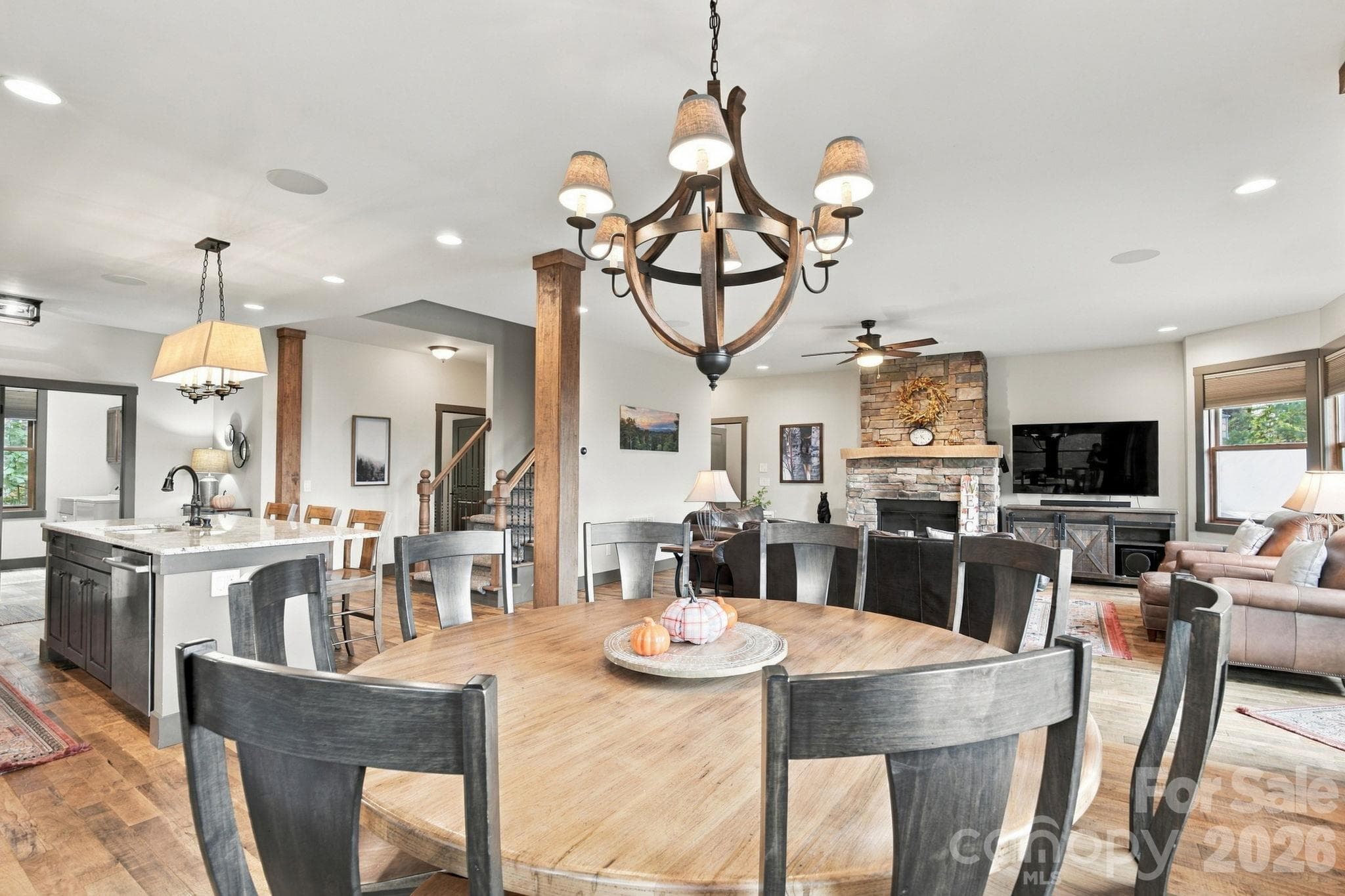 Beautiful round dining room that seats 8 looking into the living room area with beautiful hardwood pillar accents. - 1206 River Stone Drive, Laurel Springs