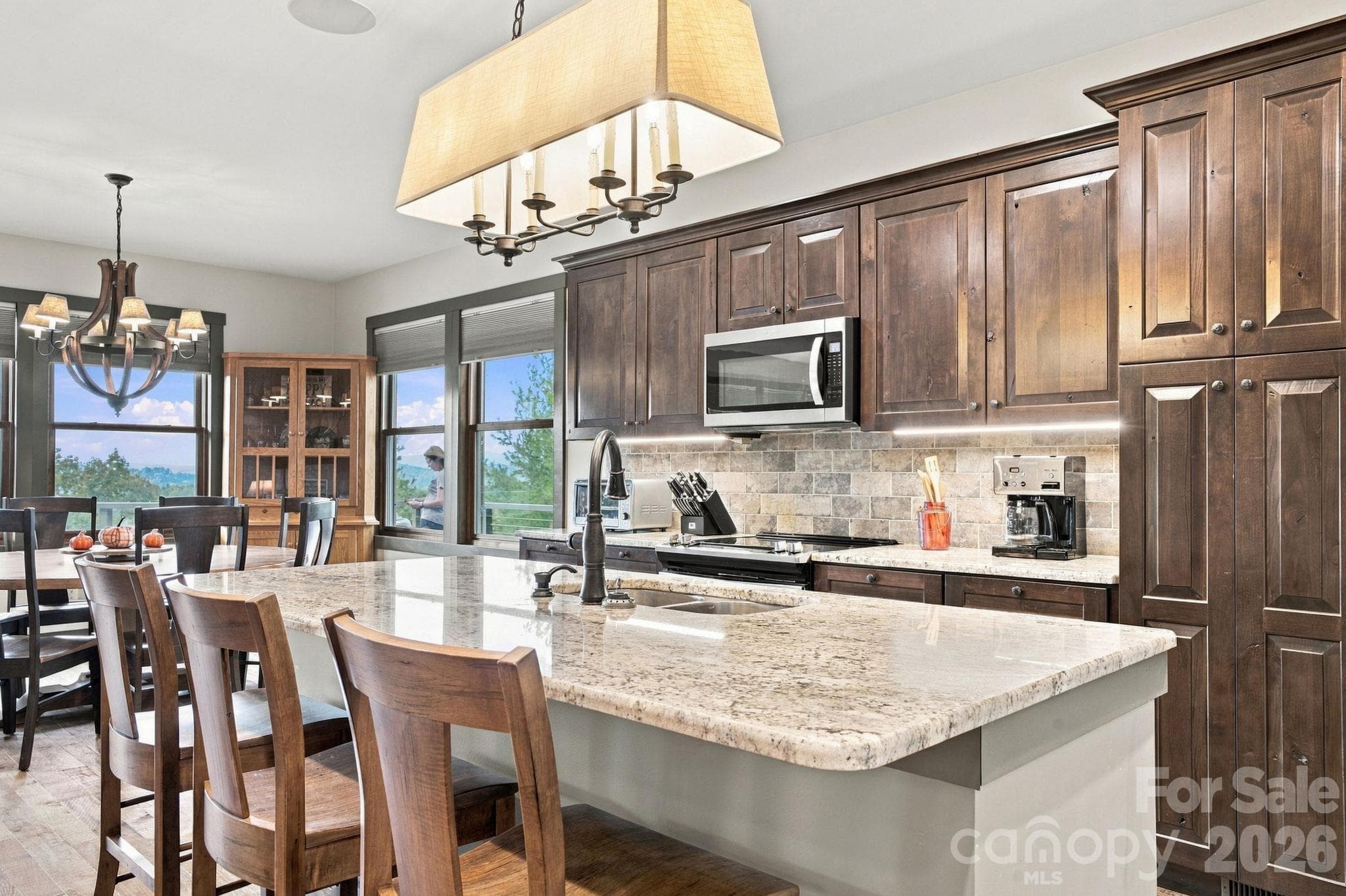 Oak corner cabinet in the dining room with a great view of the mountains as you sit at the bar area or dining room table. - 1206 River Stone Drive, Laurel Springs