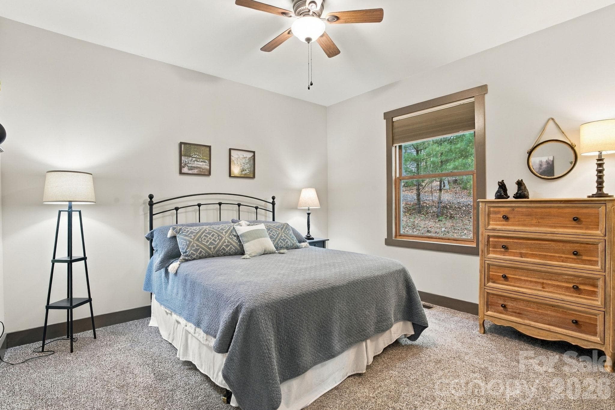Third bedroom on the main floor with ceiling fan, double door closet, blinds, and plush carpet - 1206 River Stone Drive, Laurel Springs