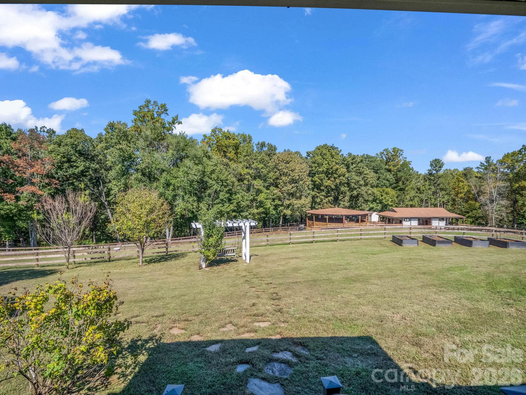 View of Barns and Round Pen from Home! Raised Garden Beds too! - 401 Over Hill Drive, Tryon