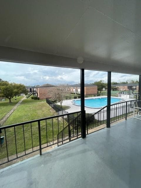 Balcony with pool and common space view - 5325 CURRY FORD RD #B205, ORLANDO