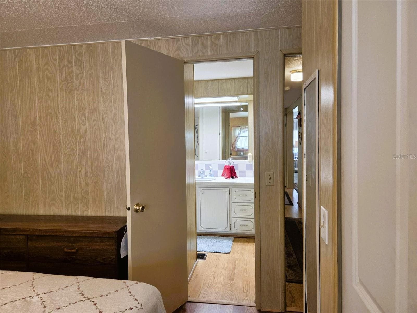 Door leading to Guest Bath from Guest Bedroom creating a private suite - 3308 OVER CUP OAK TER, SARASOTA