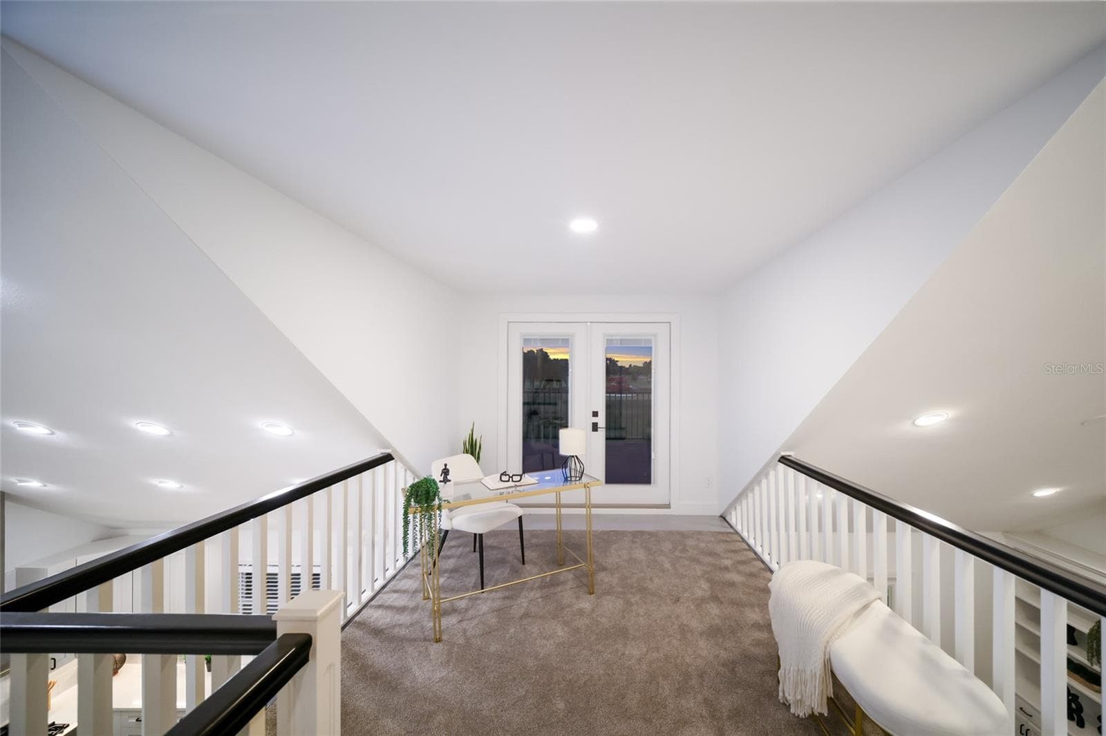 The upstairs loft offers views of the kitchen. and family room. - 5060 18TH AVE W, BRADENTON