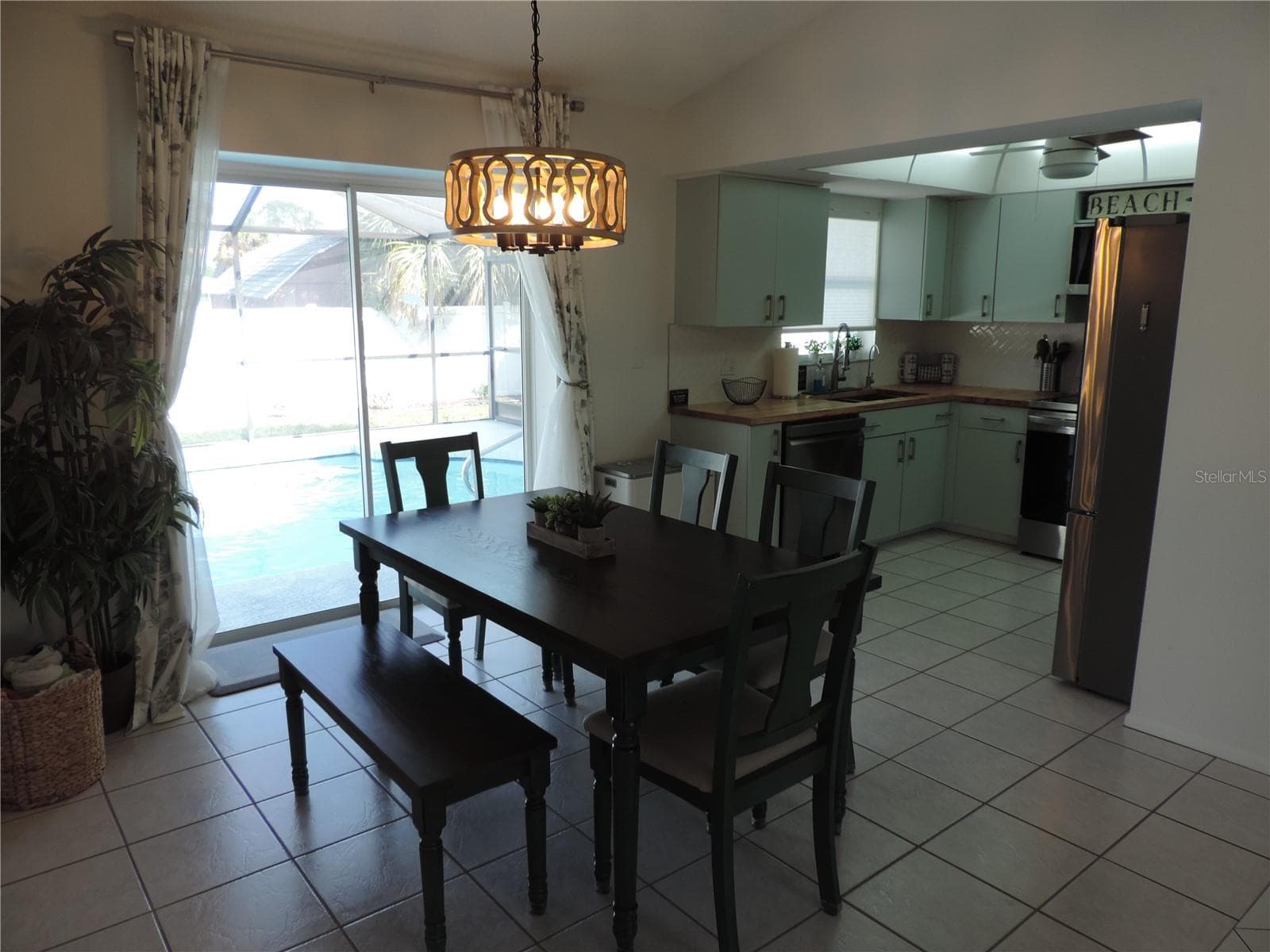 View of pool from dining room and kitchen - 1148 ROYAL RD, VENICE