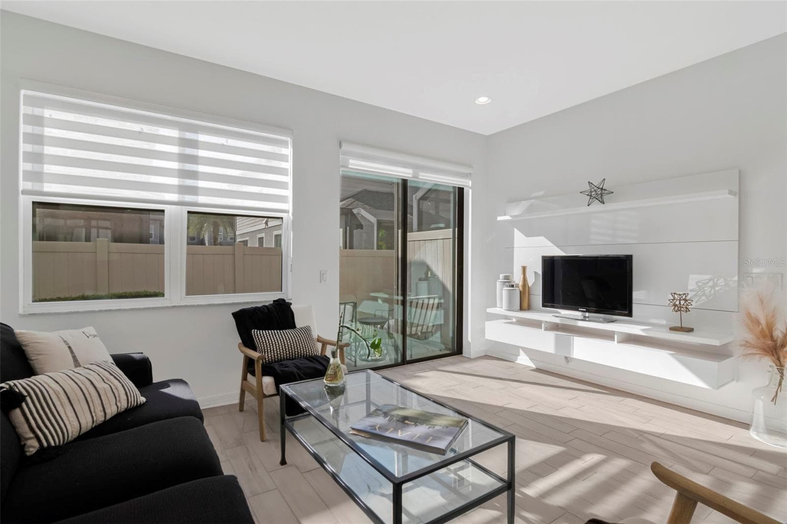 Bright and airy living room filled with abundant natural light. - 2455 GOLDEN PASTURE CIR, CLEARWATER