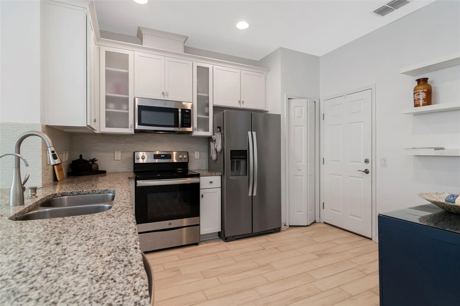 Kitchen area with convenient access to the garage. - 2455 GOLDEN PASTURE CIR, CLEARWATER