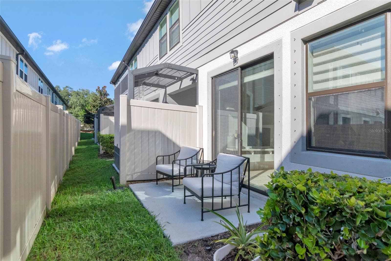 Cozy outdoor patio, perfect for relaxing and enjoying the fresh air. - 2455 GOLDEN PASTURE CIR, CLEARWATER