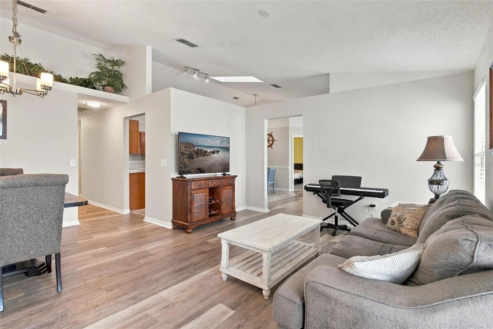 Living/Dining Area with Wood Vinyl Flooring - 945 CLEAR CREEK CIR, CLERMONT
