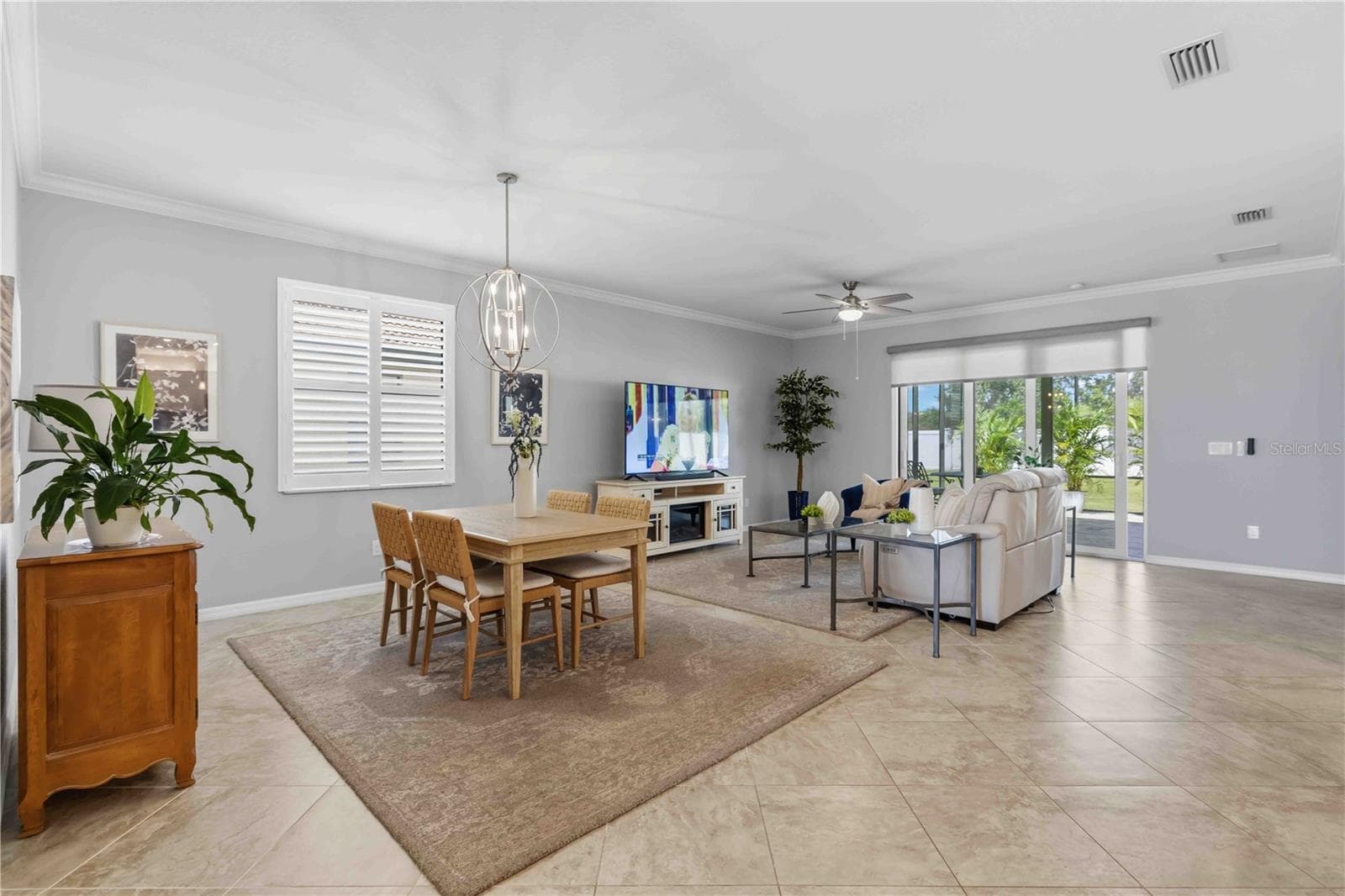 Dining and Living Areas-plantation shutters and motorized shade to the Lanai - 4523 BALTRY CT, BRADENTON