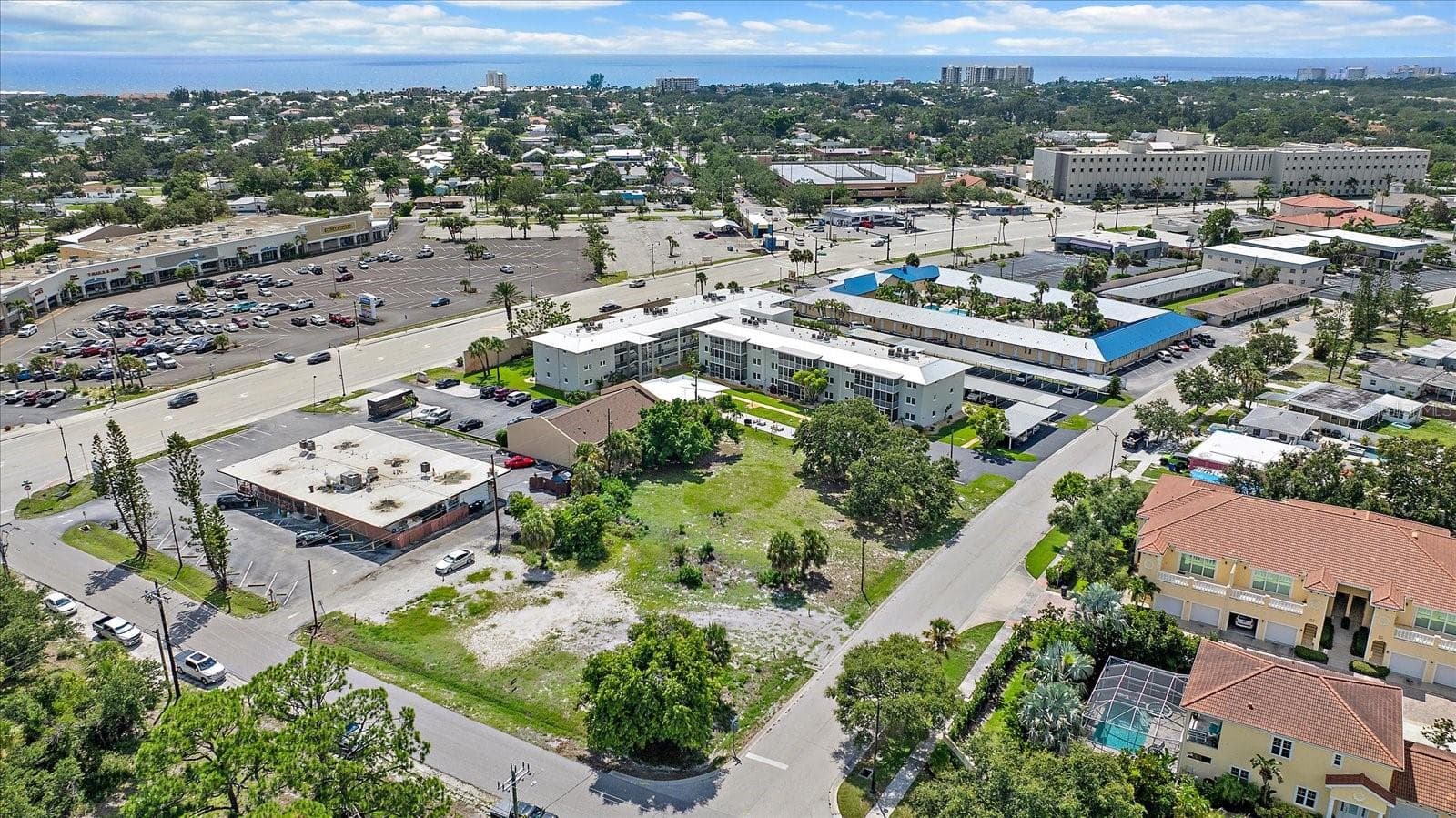 Aerial view of the lot with waterfront high-rises visible in the distance - 648 GUILD DR, VENICE
