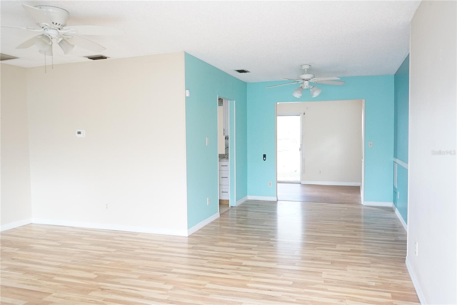 living room and blue dining area - 703 HUXLEY PL, SUN CITY CENTER