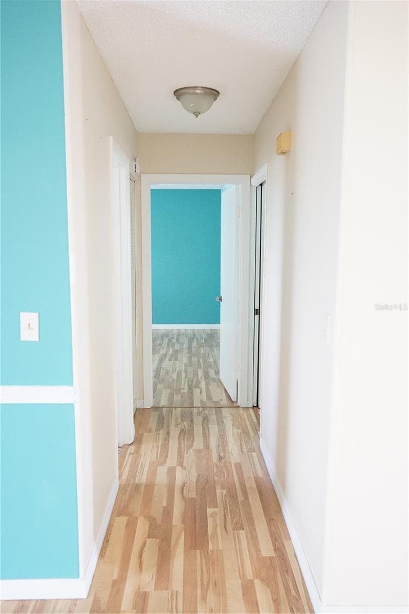 hallway to bedrooms - 703 HUXLEY PL, SUN CITY CENTER