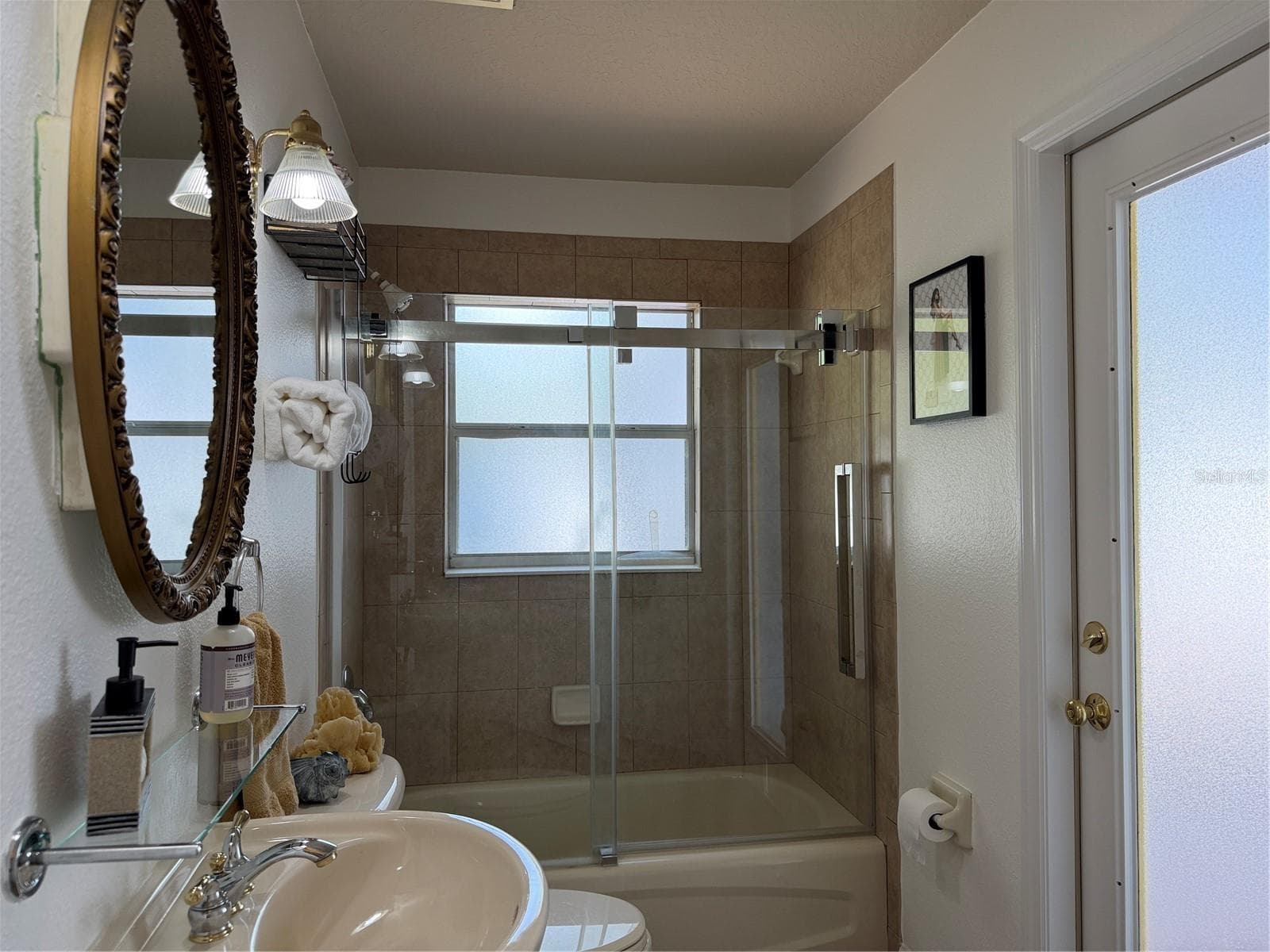 2nd bathroom has tub with shower and a quality sliding shower door - 2311 OASIS DR, LAND O LAKES