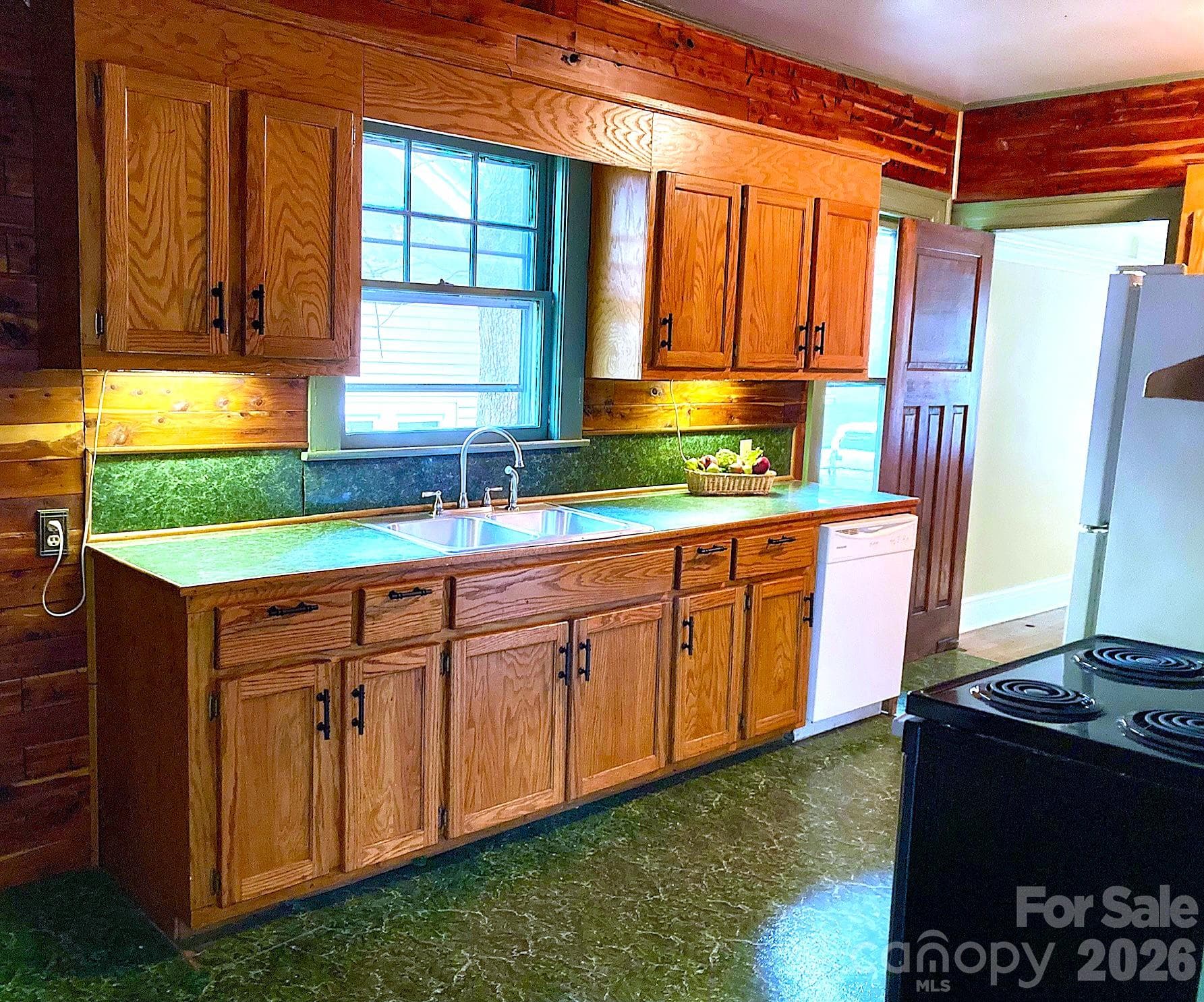 Kitchen with pine paneled walls reflects the Arts & Crafts feel. - 326 S 3rd Street, Albemarle